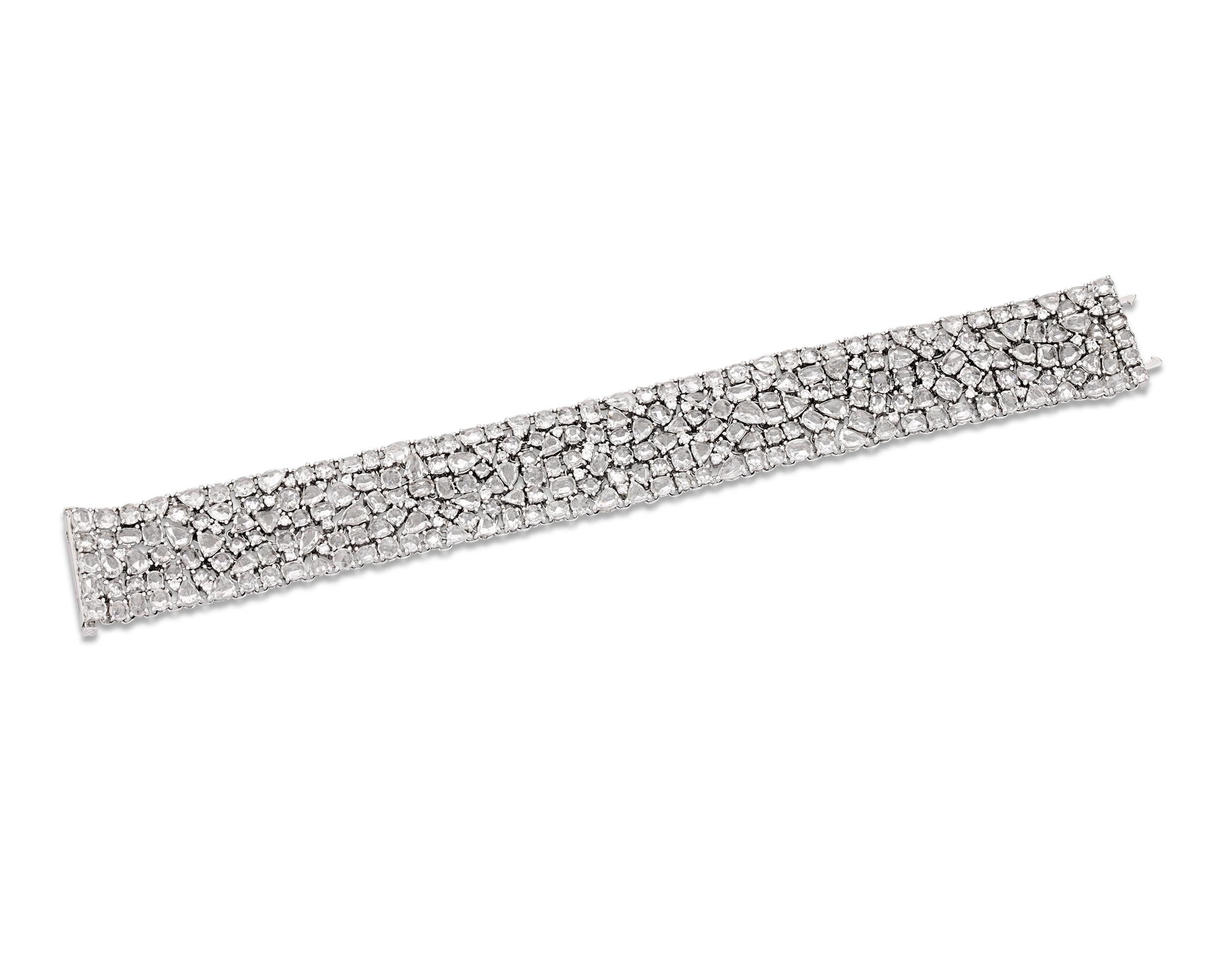 A marvelous array of 239 rose-cut diamonds cover this amazing 18K white gold bracelet. The jewels weigh a combined 22 carats and are cut in oval, pear, round, trilliant and other dazzling shapes that are meticulously fit together in a breathtaking