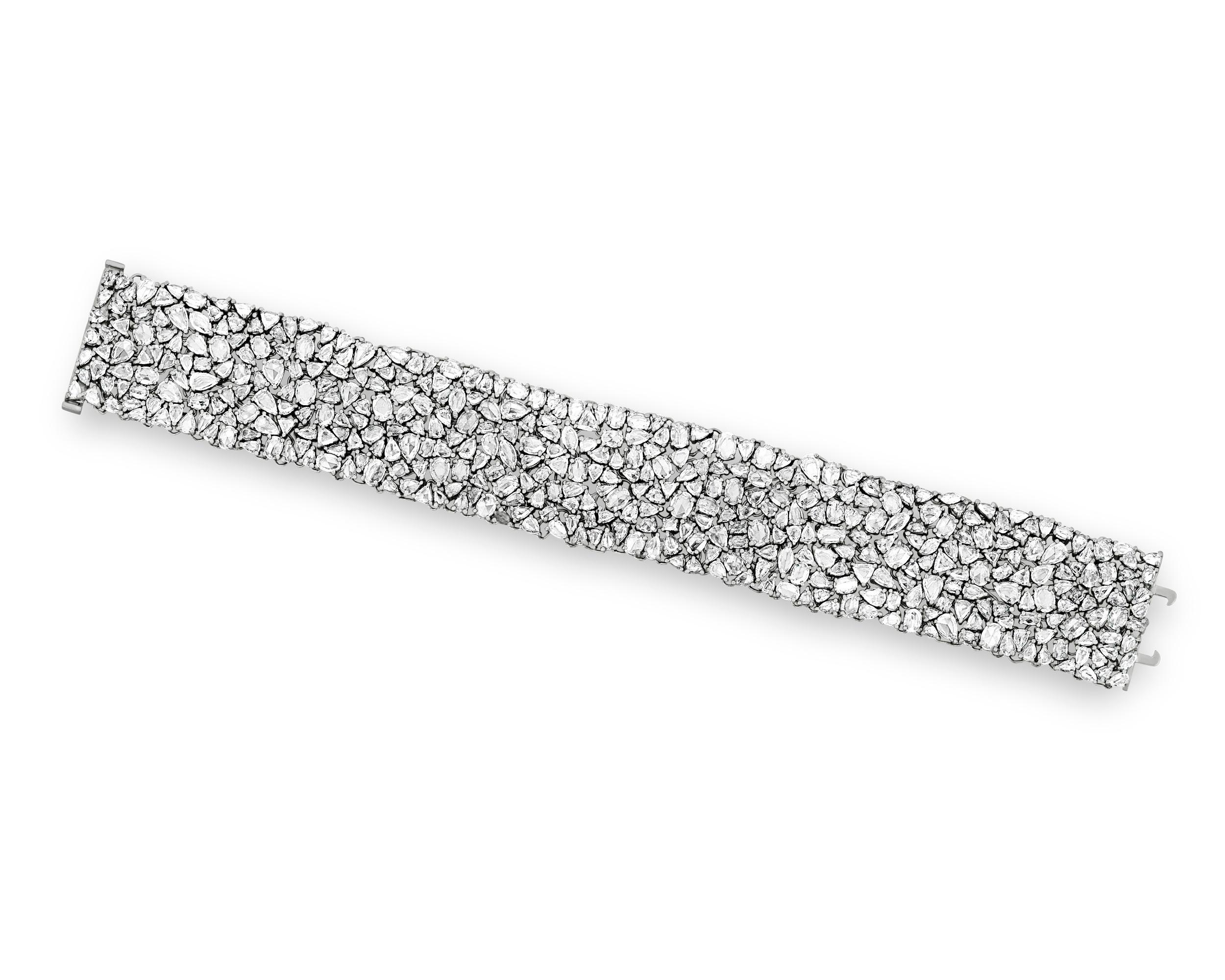Set with a remarkable 418 rose-cut diamonds totaling 26.61 carats, this bracelet reflects an abundance of light and brilliance with every movement. The rose cut — so named because it resembles the petals of a rose — features a simple structure that