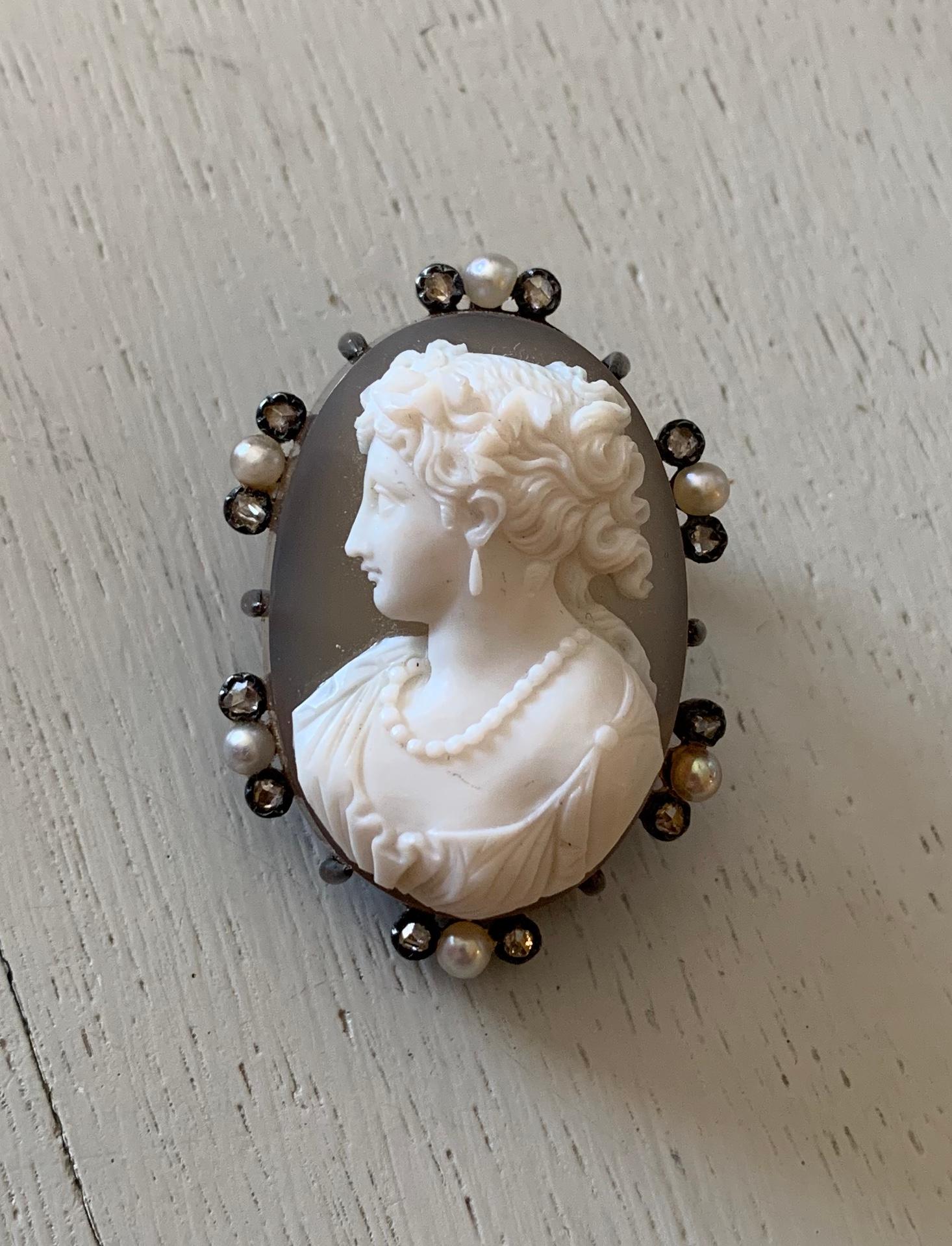 This is a stunning Antique Hardstone Cameo Pendant Brooch, framed by Rose Cut diamonds and Pearls.  The pendant is Silver atop 18 Karat Gold as was the custom of the period.  The pin stem has French guarantee stamps.  The cameo is a hardstone cameo