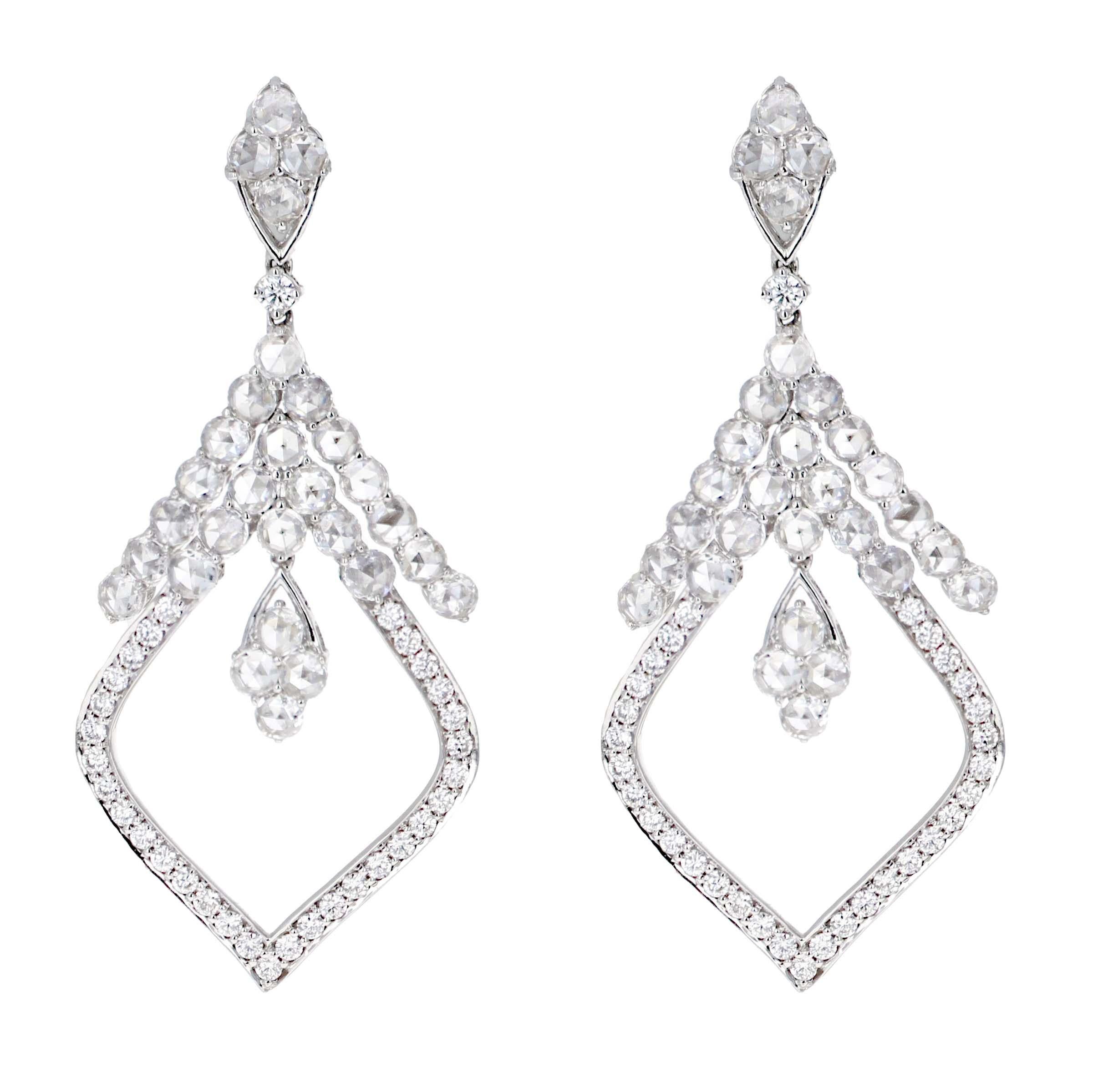 18-karat white gold chandelier rose cut diamond dangle earrings, a testament to timeless elegance and sophistication. Each earring features a cluster of four exquisite rose-cut diamonds, cascading to a display of thirteen scintillating stones,