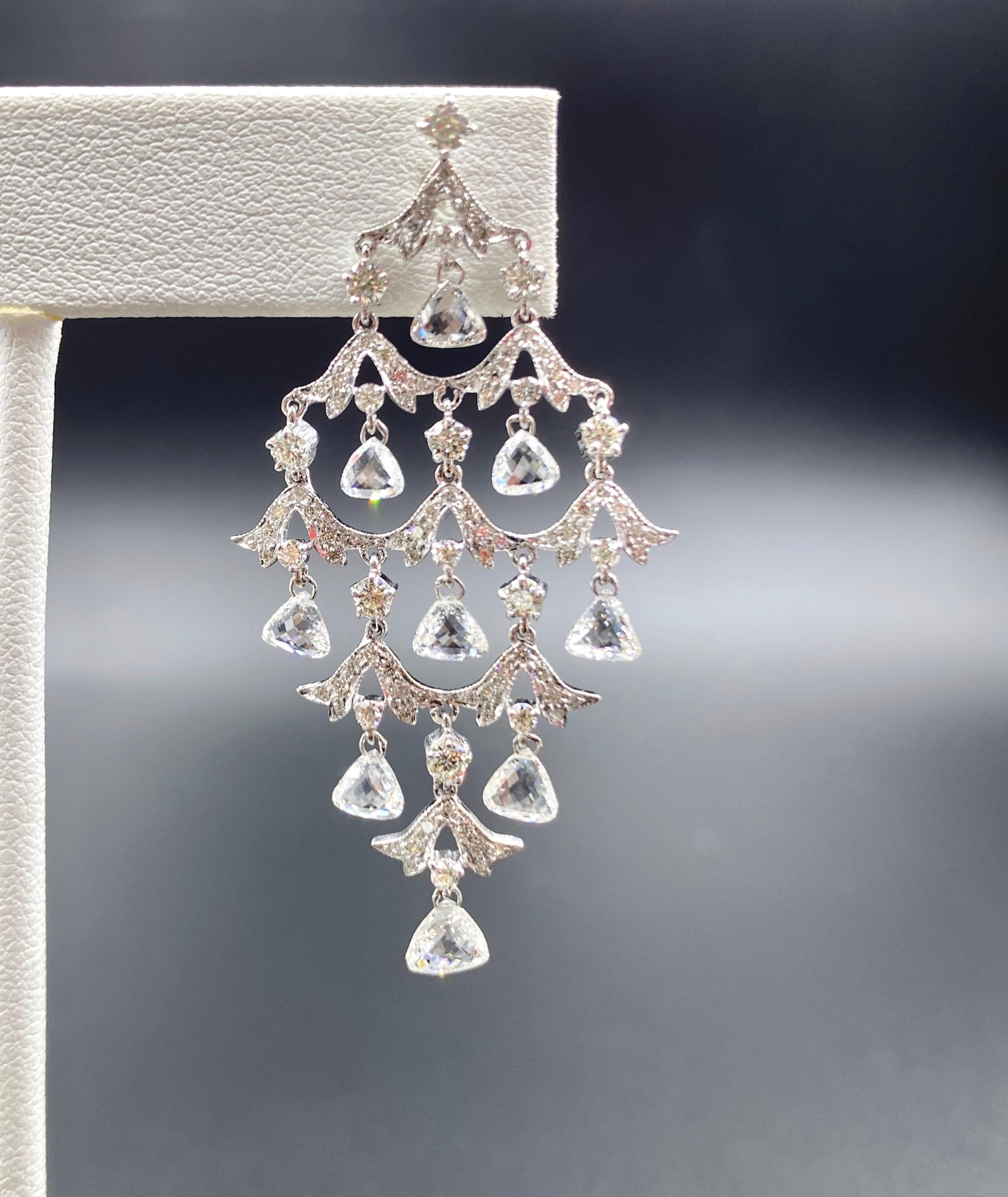 The Rose Chandelier Earrings feature 4.90 carats of triangular rose cut diamonds set in 18K white gold. A truly inspiring creation, these earrings are unbelievably light, made using minimum metal and create an illusion of floating diamonds.

Diamond