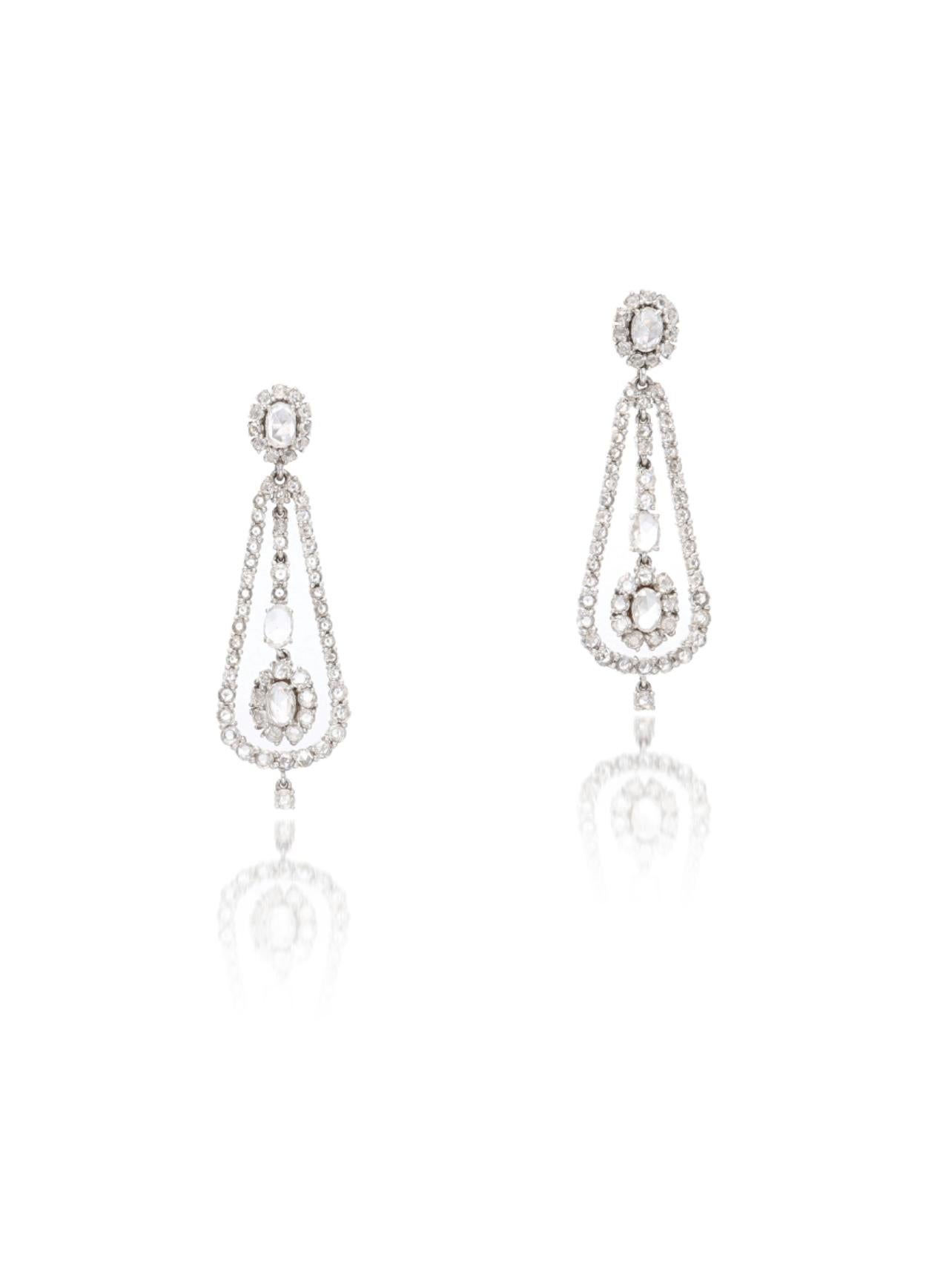 These feminine and pleasingly graceful earrings are beautifully handmade in 18k white gold. 
The details are as follows : 
Diamond weight : 2 carats + 0.74 carats ( HI  color and SI clarity ) 
Metal: 18K white gold 
Measurements : length : 1 2/3