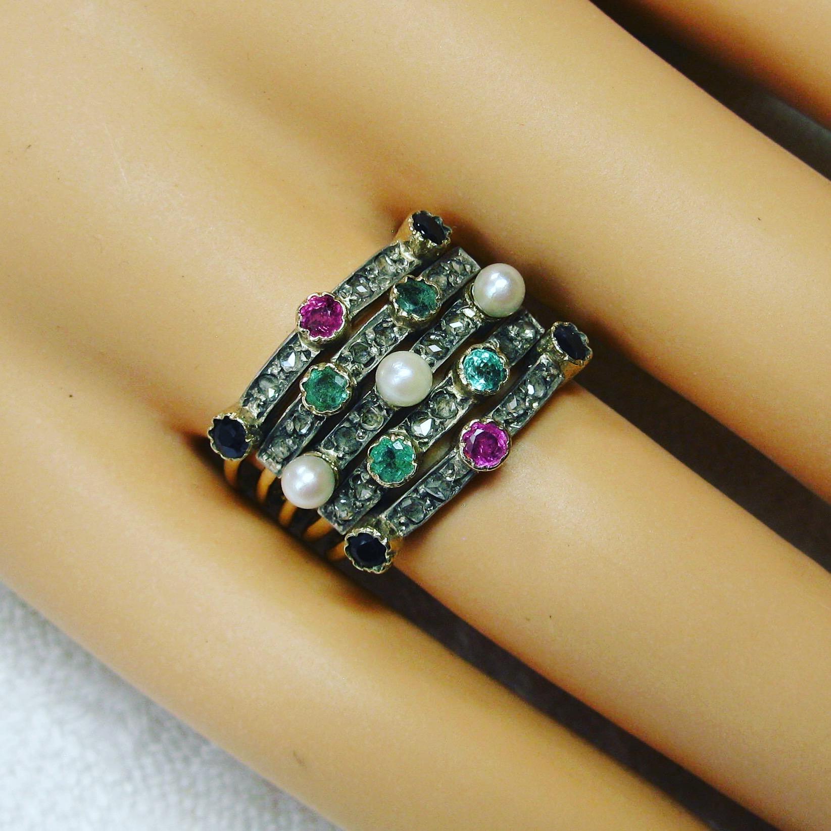 This is a spectacular antique Harem Ring with five stacking bands set with 24 sparkling Rose Cut Diamonds, Emeralds, Sapphires, Rubies and Pearls in 14 Karat Gold.  The ring is a highly desirable and very difficult to find jewel.  The ring dates to