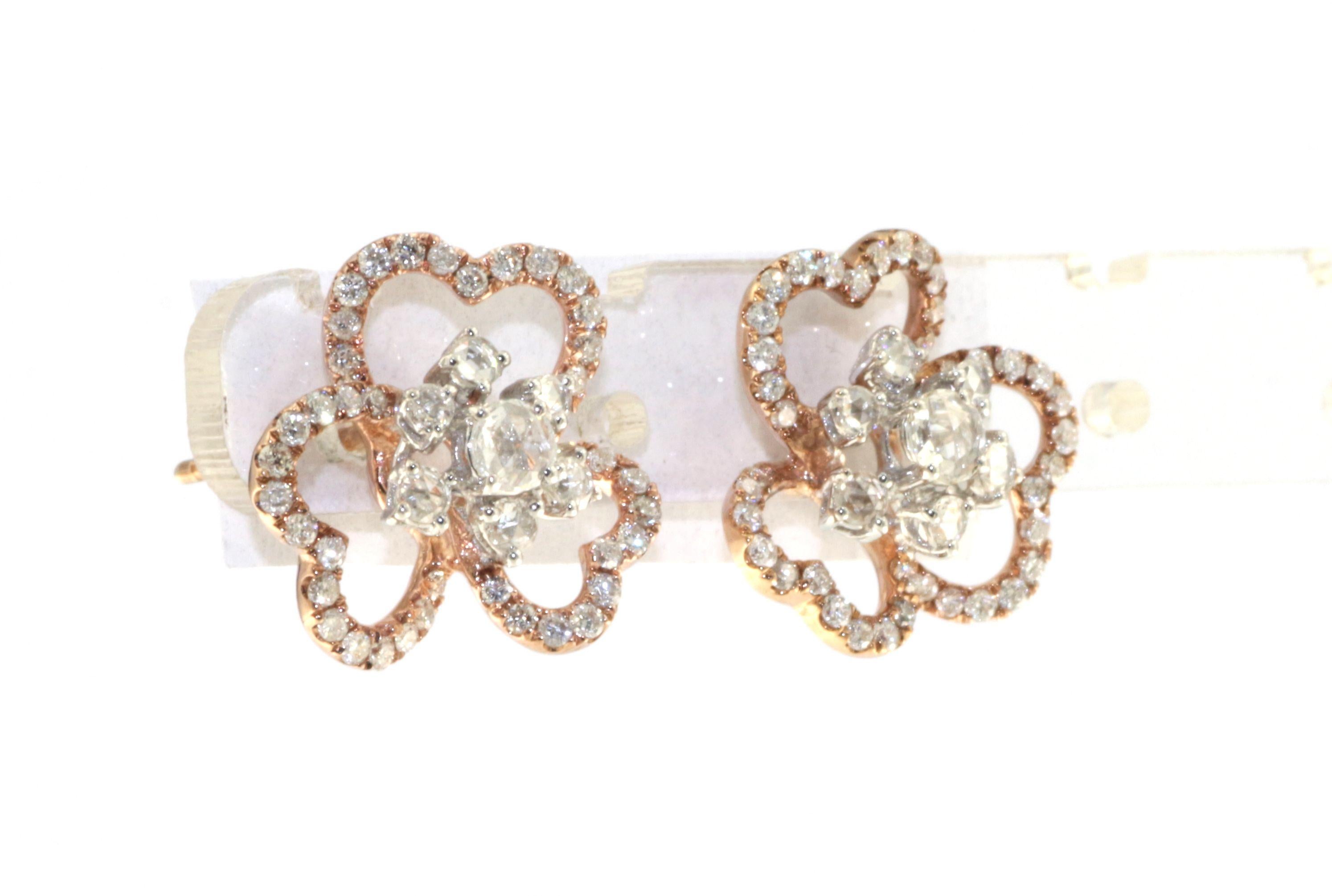 The earrings presented are an exquisite blend of classic charm and modern design. Crafted from 18K white and rose gold, they offer a dual-tone appeal that is both distinctive and timeless. The design features a floral motif, a universal symbol of