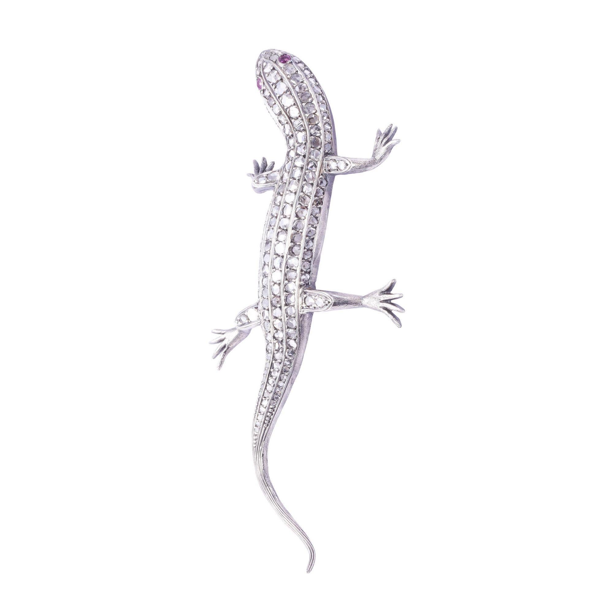 Antique rose cut diamond handmade lizard brooch. This stunning antique lizard brooch features 131 rose cut diamonds and two ruby eyes at .10 carat total weight. The lizard pin is handmade in sterling silver with milgrain detailing and hand engraving