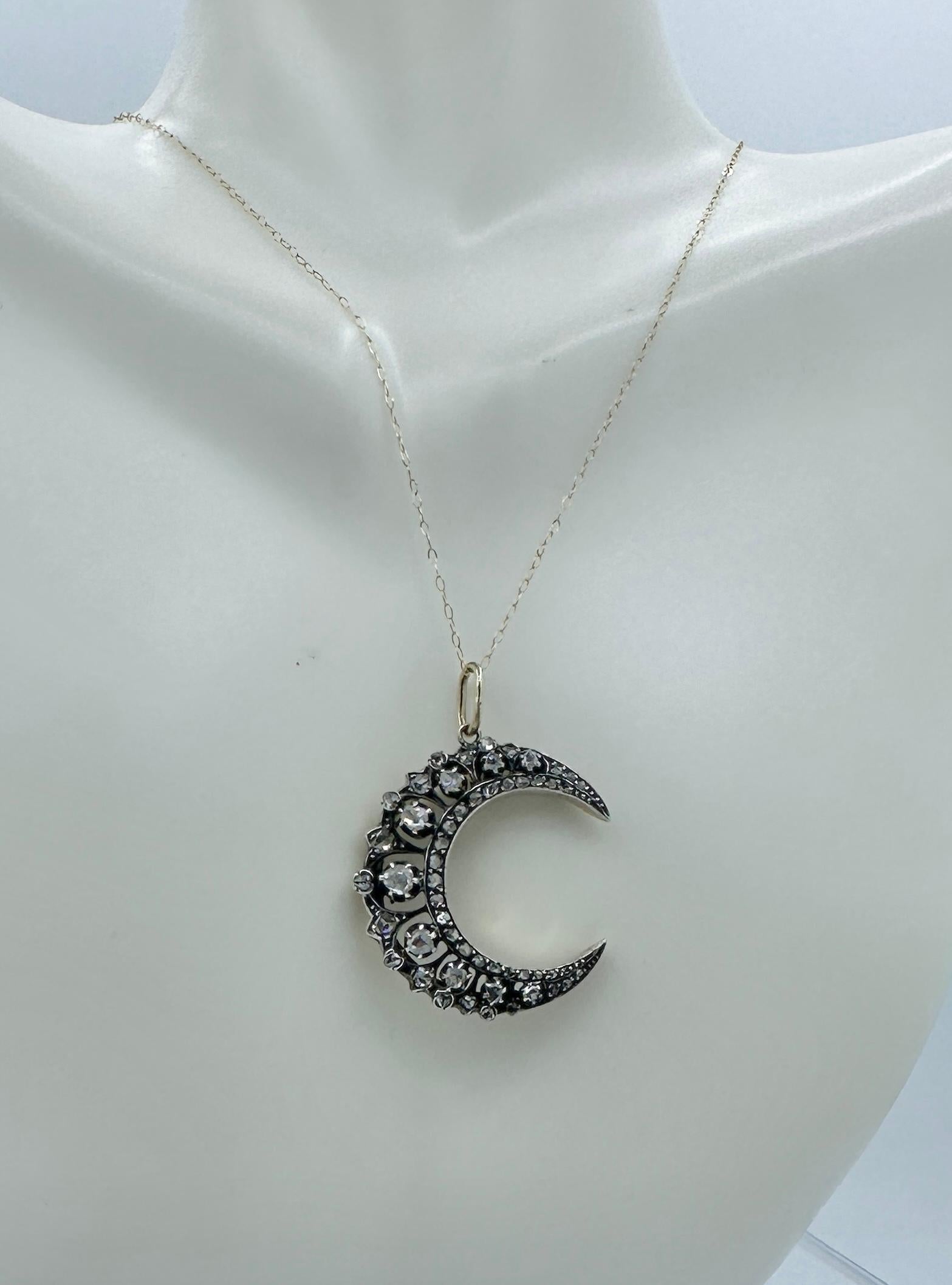 This is a gorgeous and very rare antique French Belle Epoque Rose Cut Diamond Crescent Moon Pendant in Platinum atop 18 Karat Gold.  The magnificent jewel has nine vivid sparkling antique Rose Cut Diamonds through the center that are graduated from