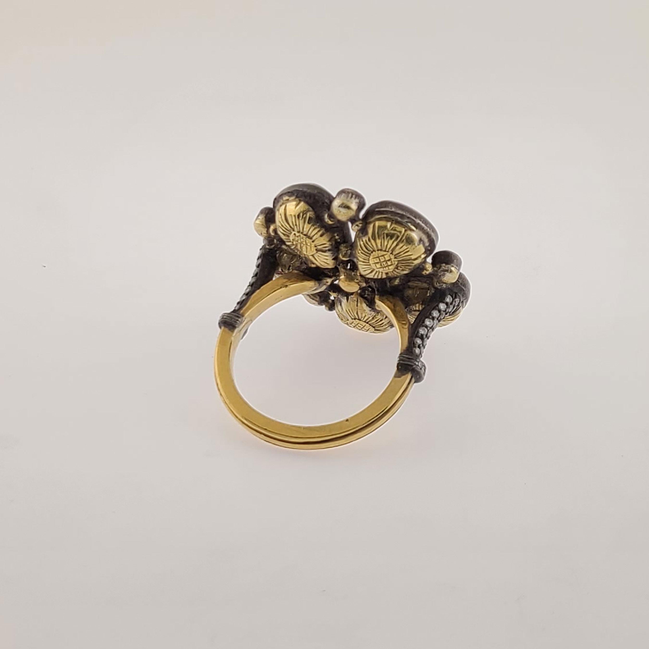 This one of a kind 18K lucky flower Gold Ring has 5 leaves of 5.11cts Pear-shape rose-cut Diamonds and those 5 leaves are bridged to each other with 5 round brilliant Diamonds. The middle of the flower has another small round brilliant Diamonds to