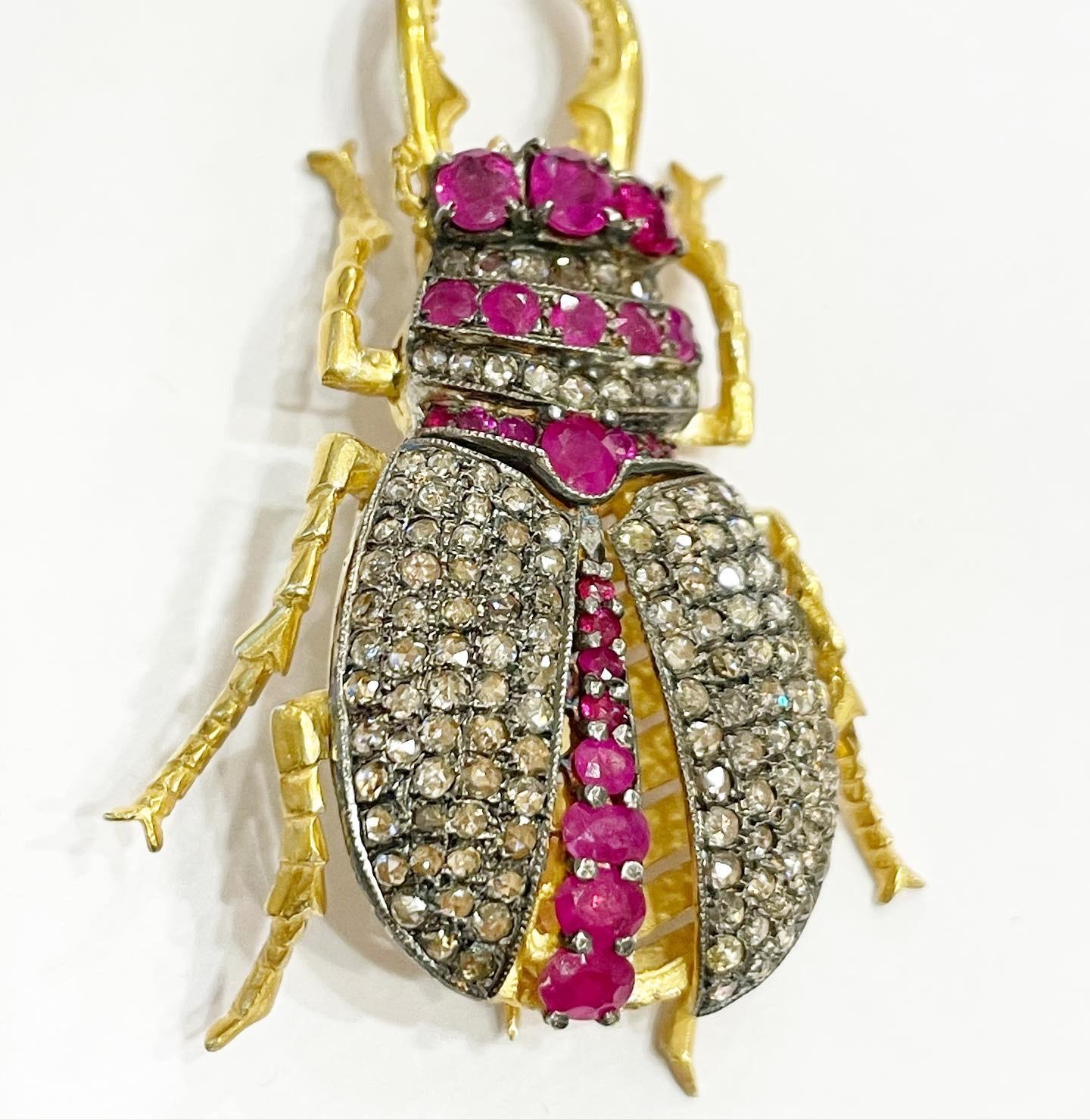 Beetle form brooch pendant, set with rose cut diamonds totaling approximately 2 Carats and further set with round and oval rubys. 
Vermeil and silver.
This piece is masterfully articulated, having movable Wings and legs. 
Has an attached bail on the