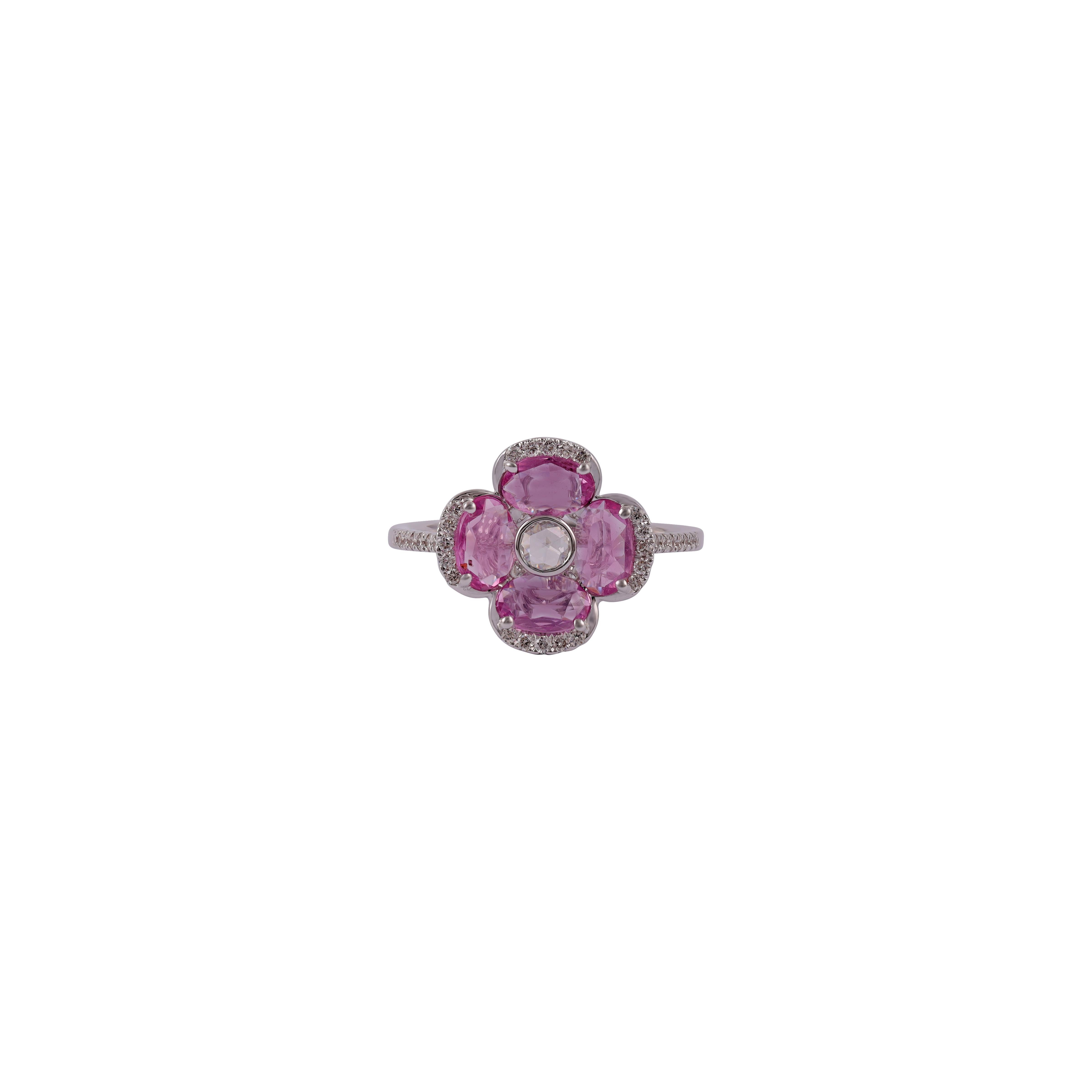 Rose cut Diamond surrounded by Oval Pink Sapphire Flower Ring
1 Rose cut  Diamond - 0.06 CTS
4 Oval Pink Sapphire - 1.34 CTS
36 Round Brilliant Cut 0.22 CTS
18k White Gold.

