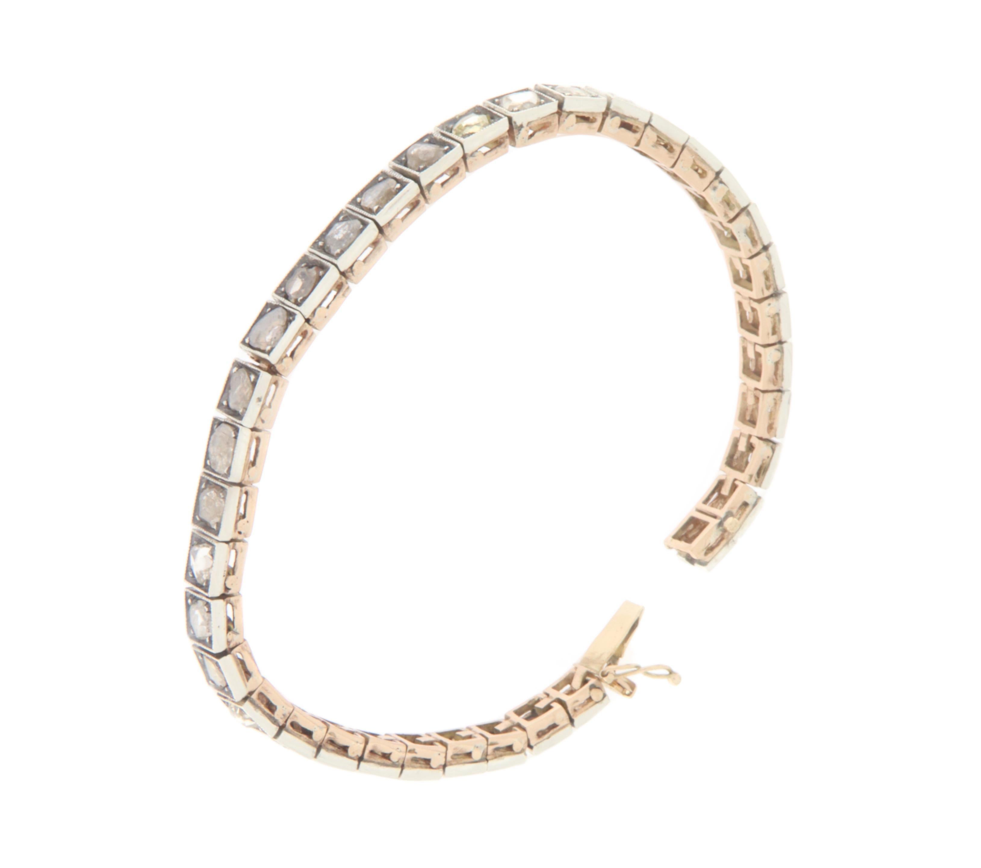 This elegant tennis bracelet is a refined example of high jewelry, crafted in 14-karat yellow gold and 800-millesimal silver. The bracelet is adorned with a row of rose-cut diamonds, each carefully set to highlight its unique brilliance and sparkle.
