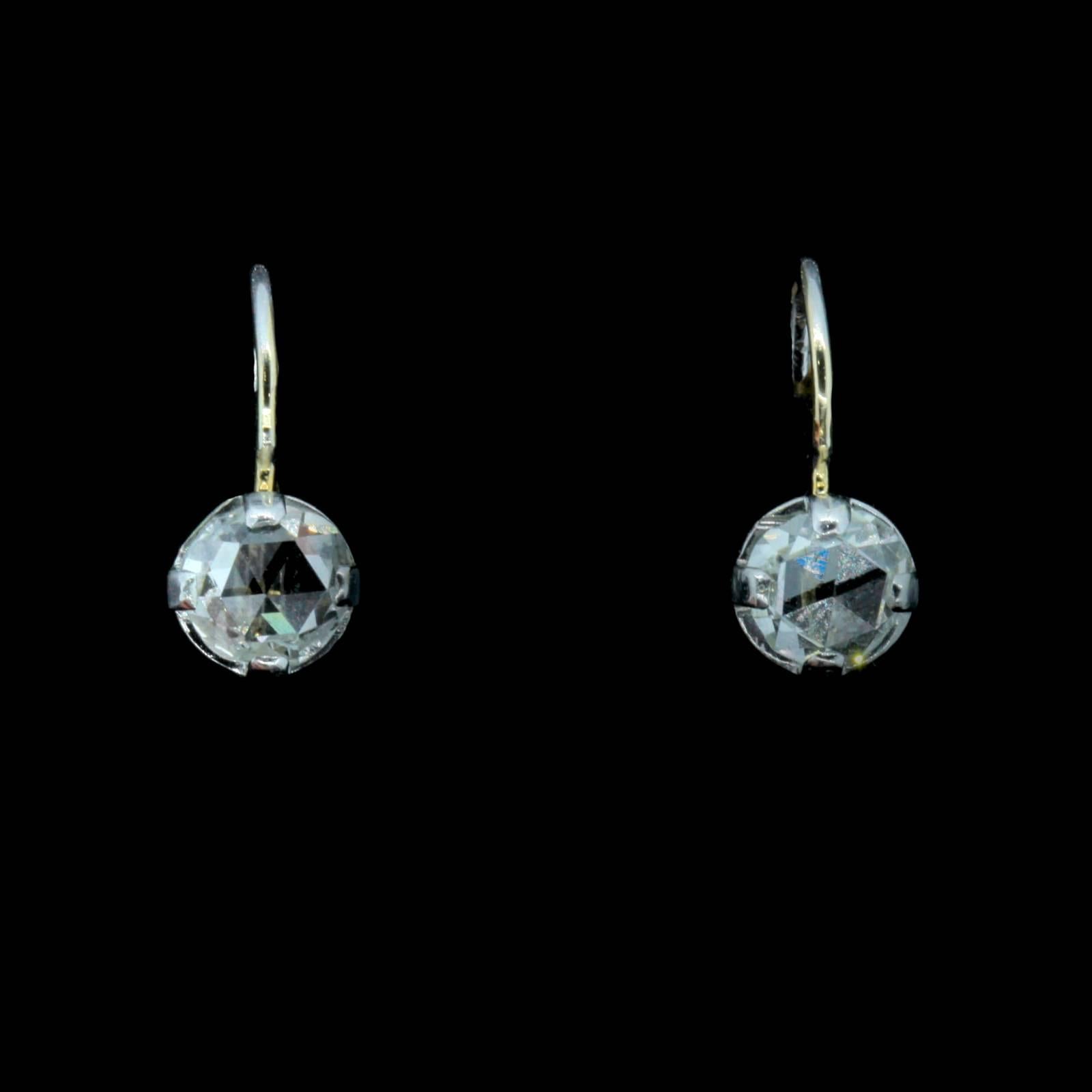 Simple and beautiful!  A pair of 14KT white gold earrings set with two Rose Cut Diamonds, both weigh a total of approx. 1.28 carats of I/J color - VS1/SI1 clarity.  The diamonds are set in a fluted four prong baskets with lever backs.  Just Lovely!