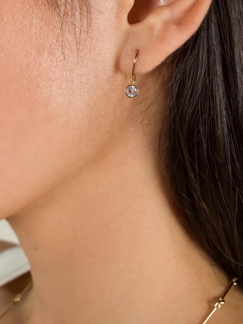 Using unique rose cut moonstones these earrings will surely become an everyday staple piece. The moonstones are 4mm in diameter, rose cut, bezel set, and hung on a 14k solid gold French ear wire.

-14k solid Yellow, White or Rose Gold
-4mm rose cut