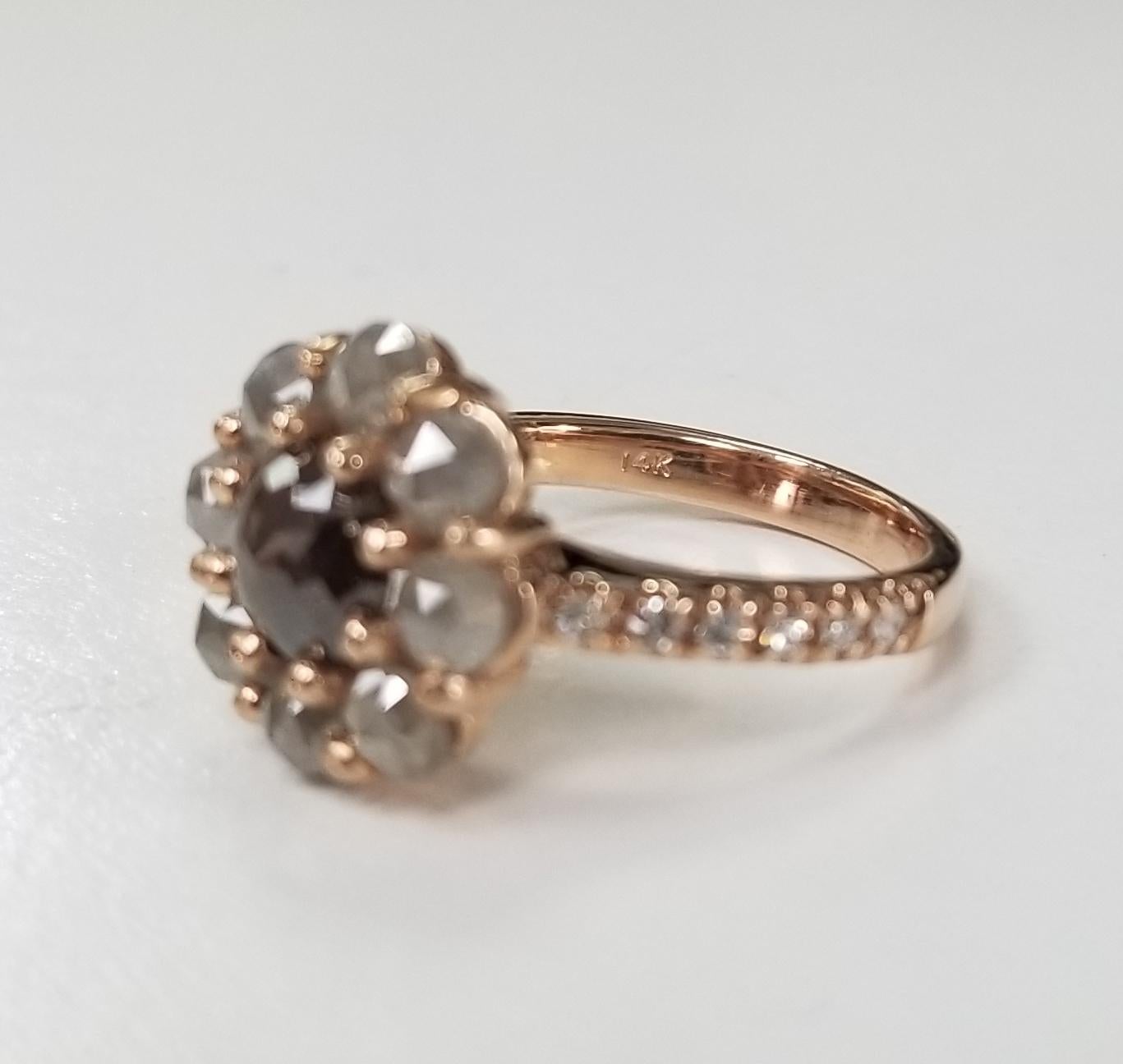 14k rose gold diamond ring containing 1 round brown rose cut diamond weighing .87pts. and 8 round grey rose cut diamonds weighing 1.75cts. with 12 round single cut diamonds on the shank weighing .17pts.  This ring is a size 6 but we will size to fit