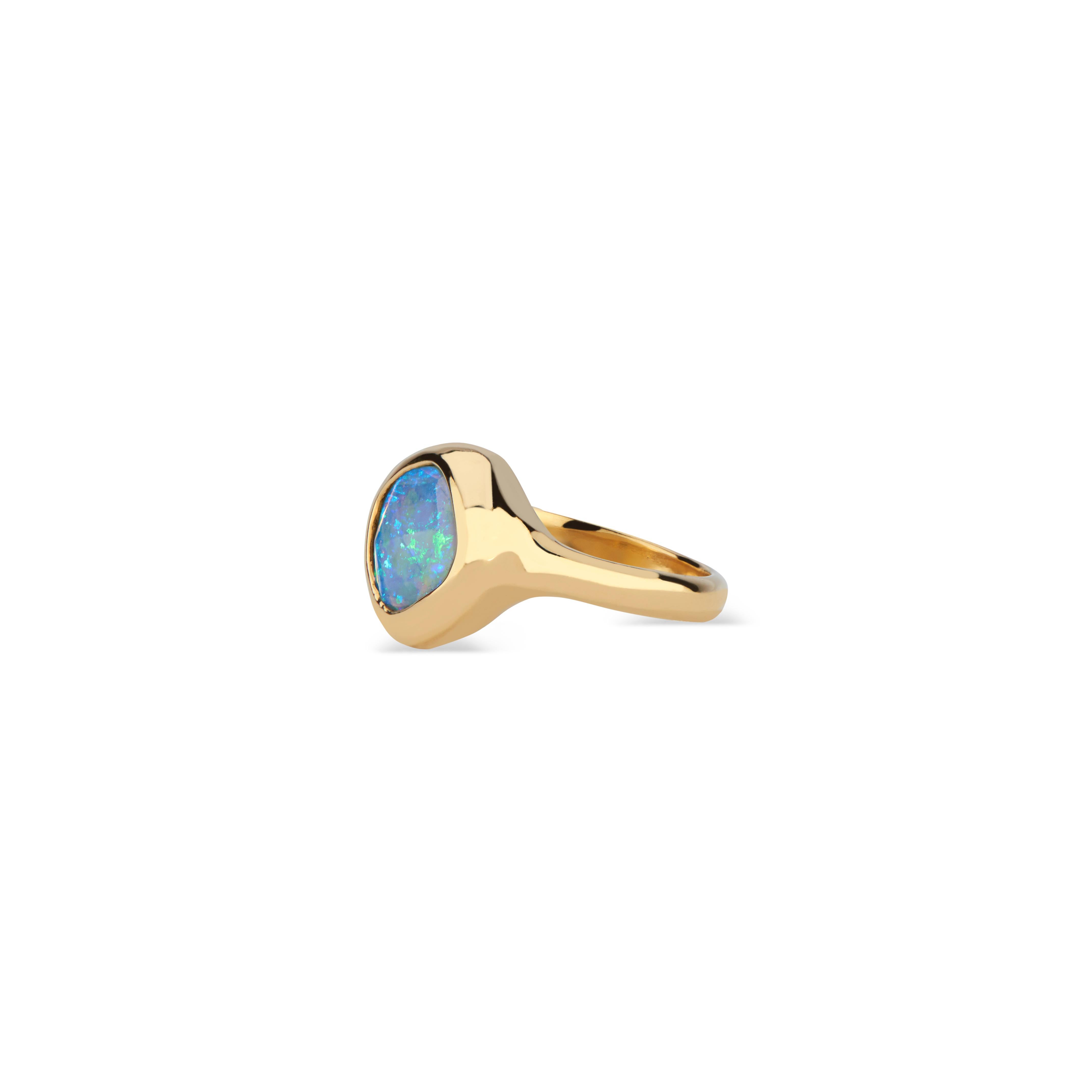 A uniquely-shaped opal stone from Ethiopia, rose cut, and set in a custom-designed bezel ring of 22k gold. The vibrancy of the stone is enhanced by the 92% gold content. 