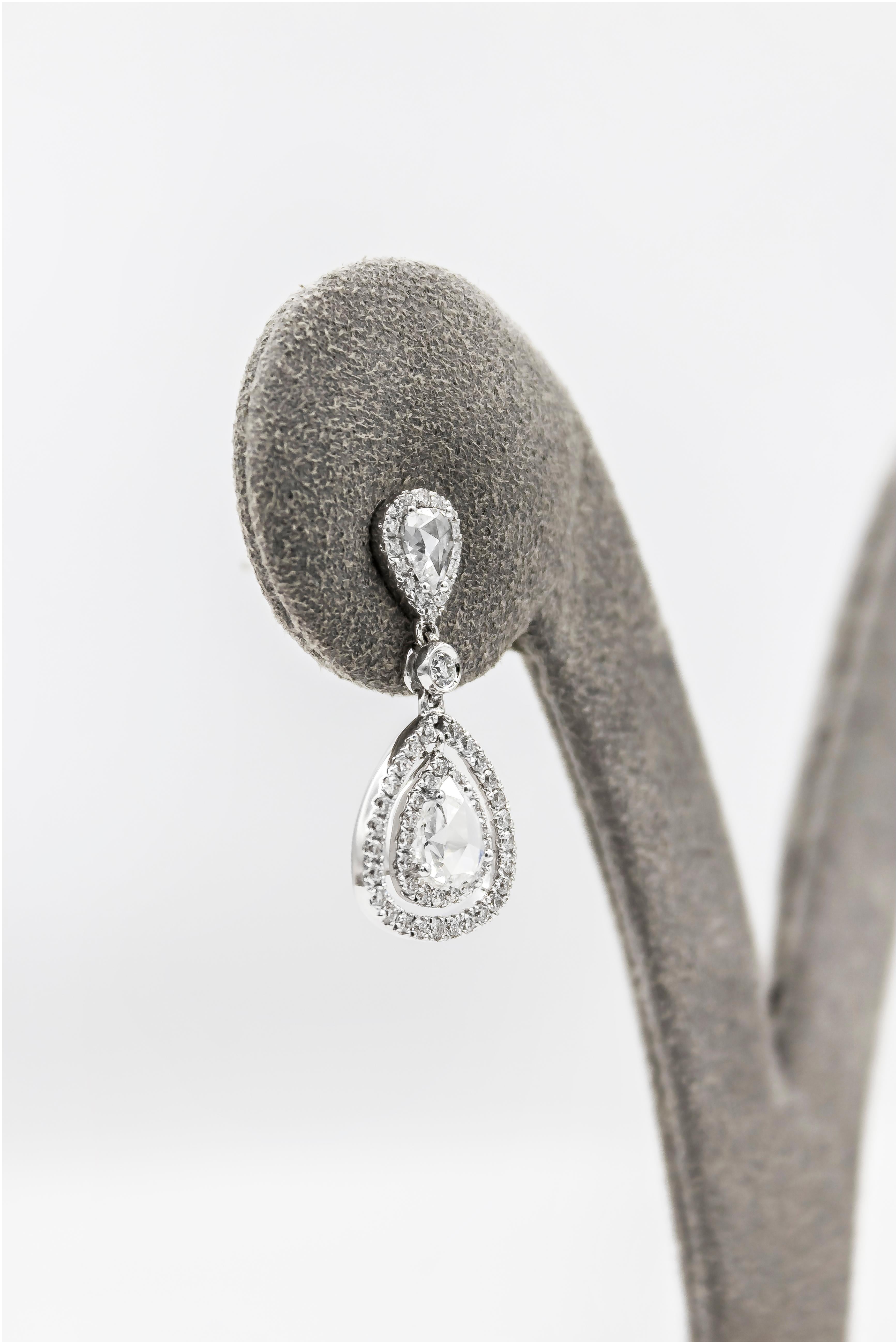 Showcasing a beautiful pear shape diamonds, set in a double halo of open-work design. Suspended on a bezel set diamond and pear shape diamonds in a halo design. Diamonds weigh 1.53 carats total and Finely made in 18k white gold.

Style available in