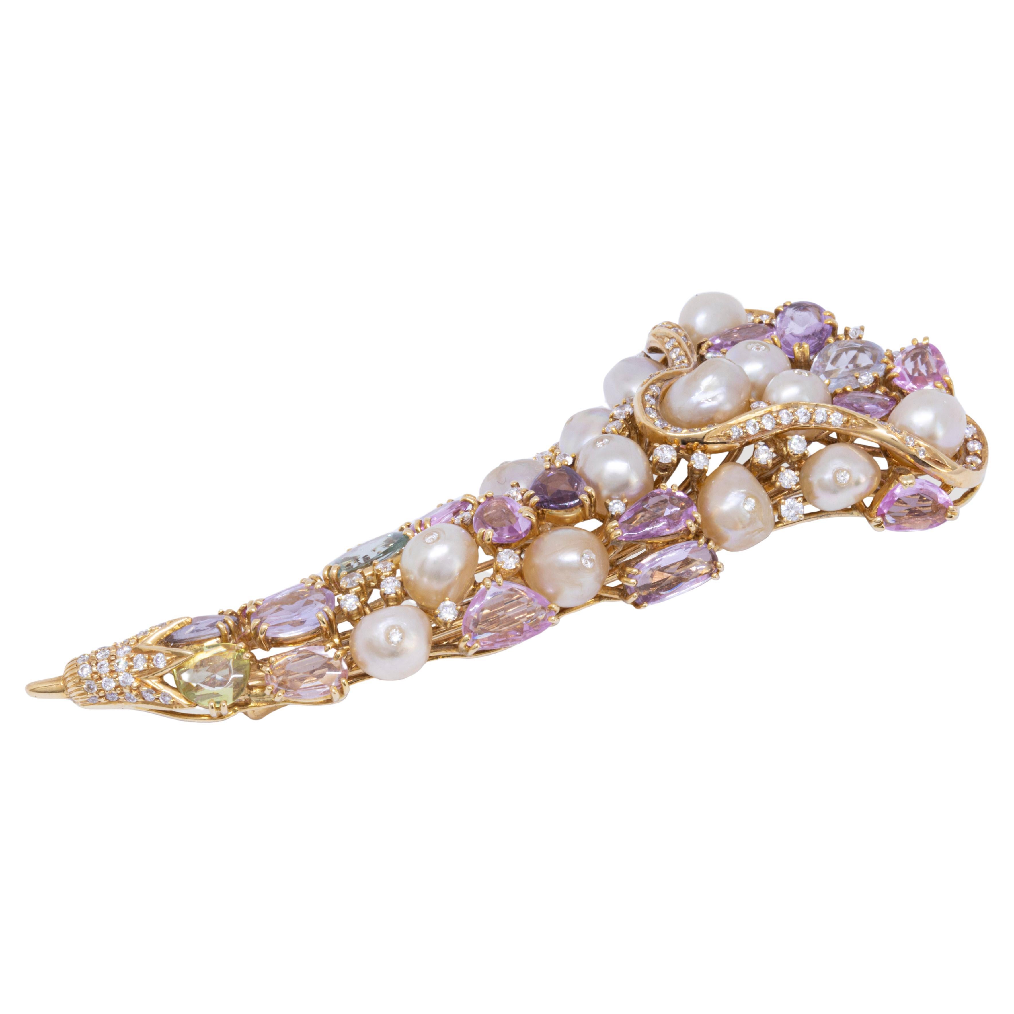 An eye catching cluster of baroque natural pearls, multiple color rose cut sapphires and diamonds.
The gemstones come together to form a unique flower bouquet brooch. 
The natural flow of the 18k yellow gold, diamond studded border adds a beautiful