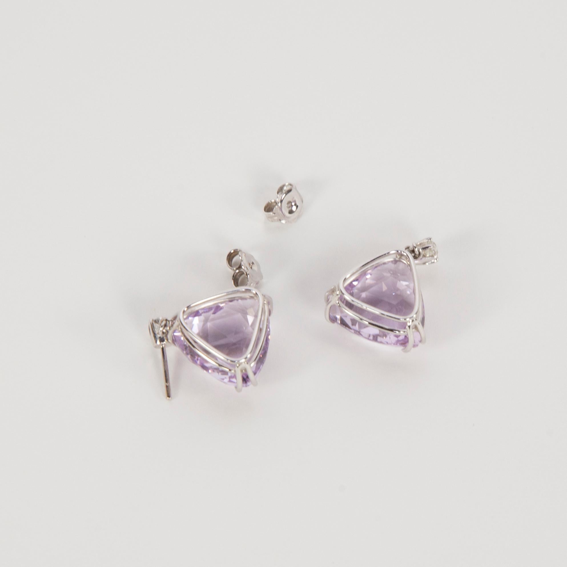 Pair of Amethyst and Diamond Dangle Earrings hand crafted in 14k white gold; featuring 2 Trillion Checker-cut Rose de France Amethyst; 16mm x 15.92mm each with an approx. total weight of 27.56 Carat.; 30mm x 21mm each; enhanced by 2 Old-European cut