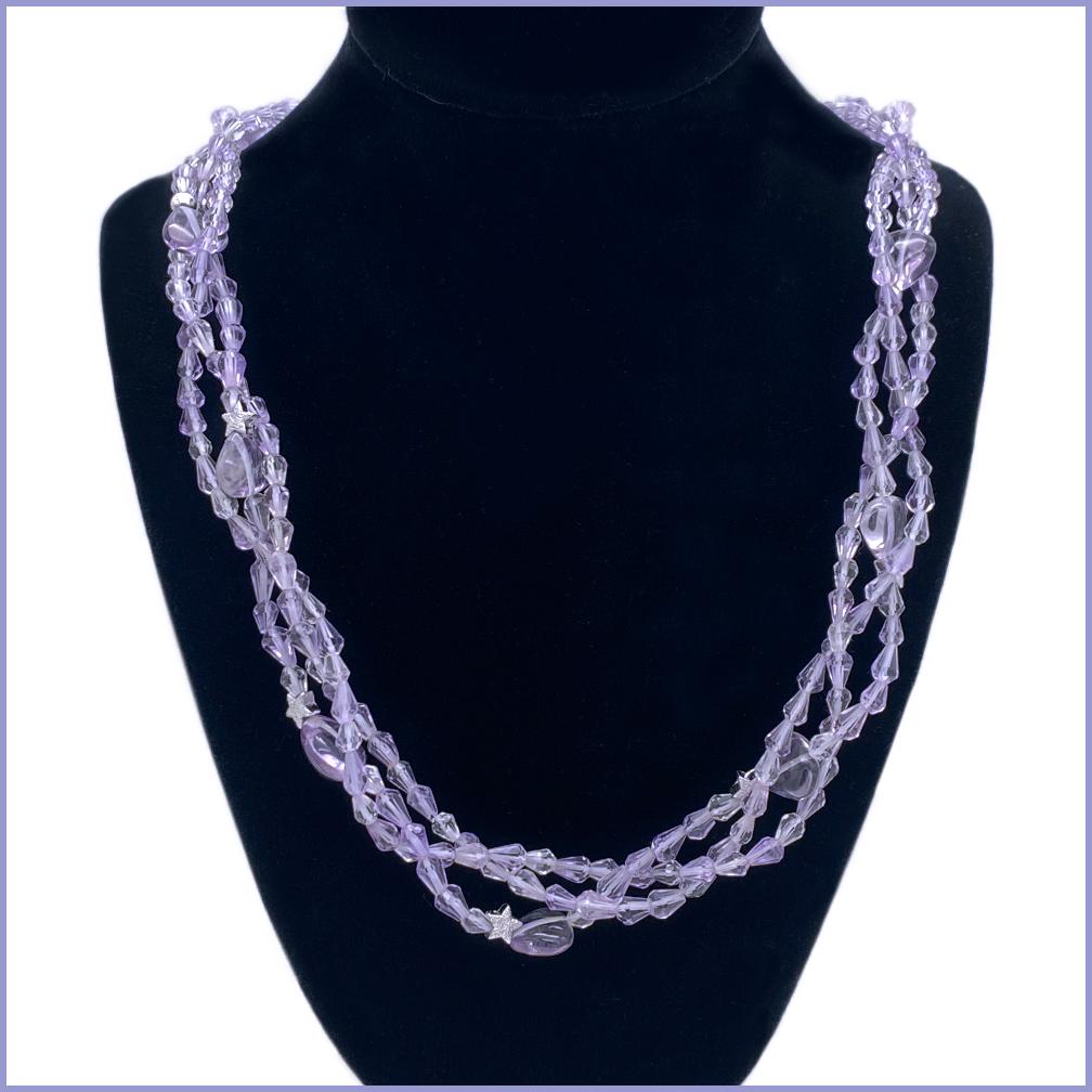 This is a Rose de France amethyst triple strand necklace. It was braided with 3-5mm faceted tear drop amethysts and nine smooth heart shaped amethyst beads. Five sterling stars and a clasp completes this delicate light lavender color necklace. We