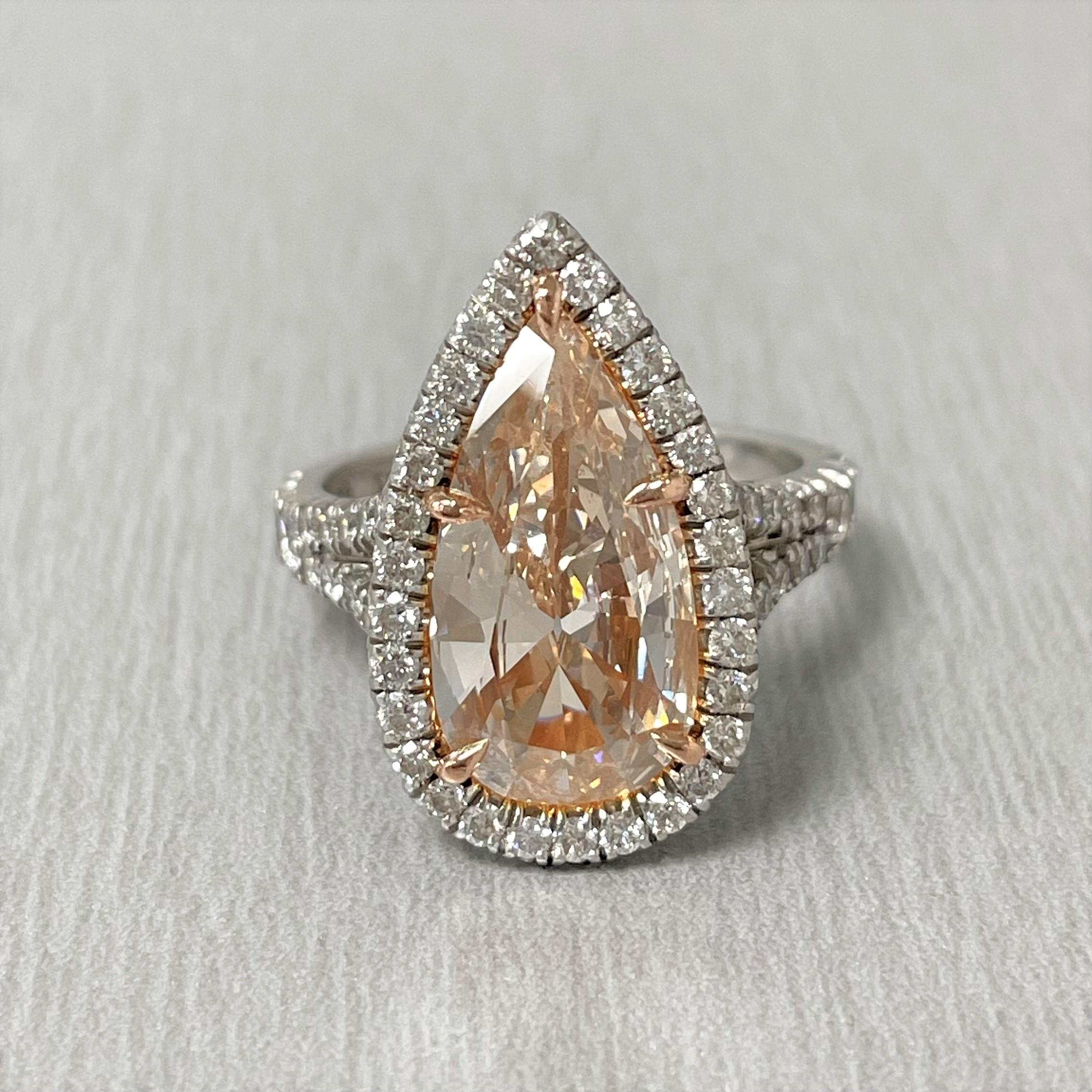 A stunning Pinkish diamond ring, the Rose features a elegant design with oversized Pinkish Pear Shape diamond expertly set in a statement halo setting to impress and captivate.

Center Diamond Shape: Pear
Center Diamond Weight: 3.03 ct (Measures