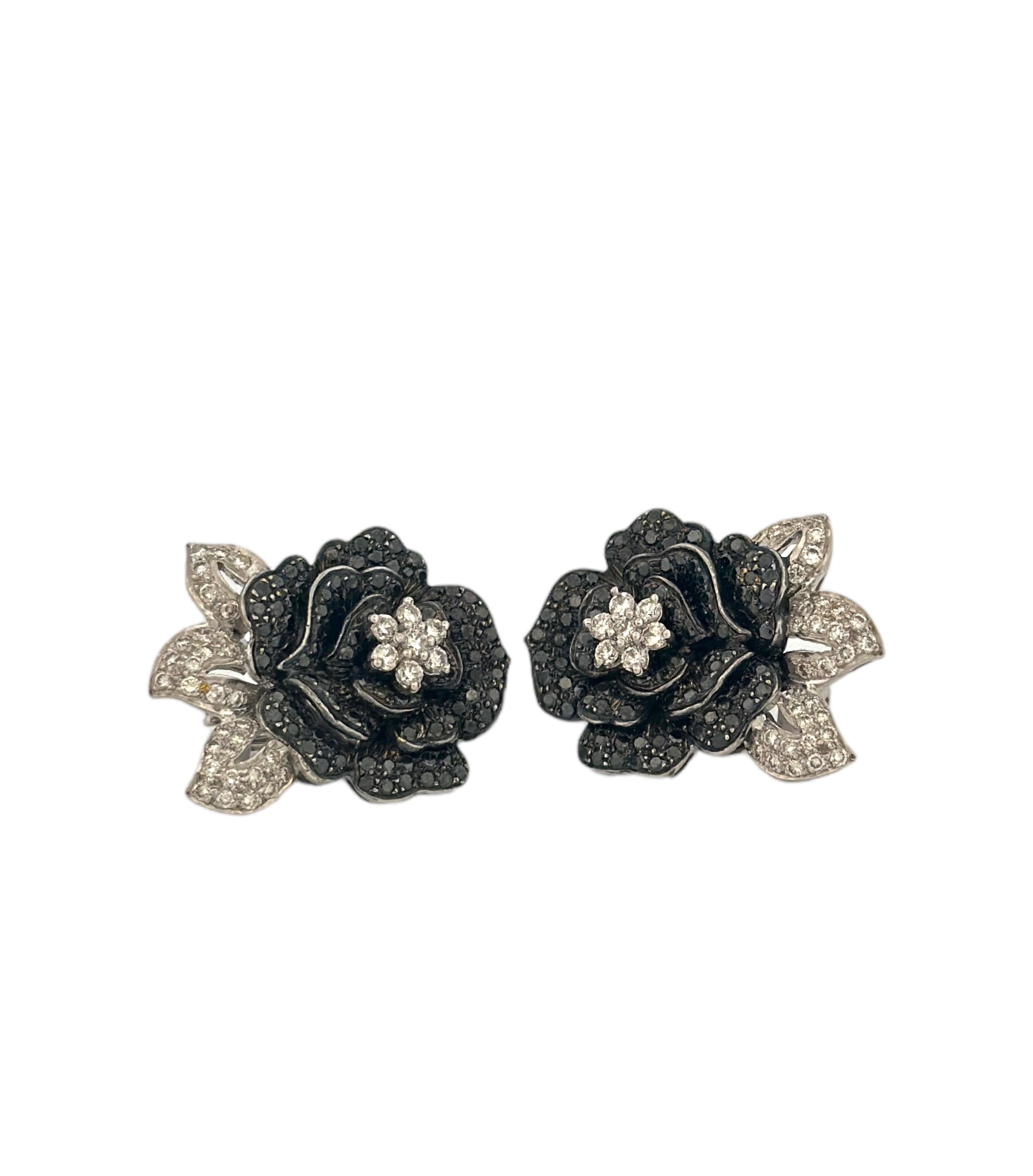 This early 20th-century rose-shaped black and white diamond earring is a striking testament to the elegance and craftsmanship of the era. It features a  white diamond at center , radiating brilliance and serving as the heart of a beautifully