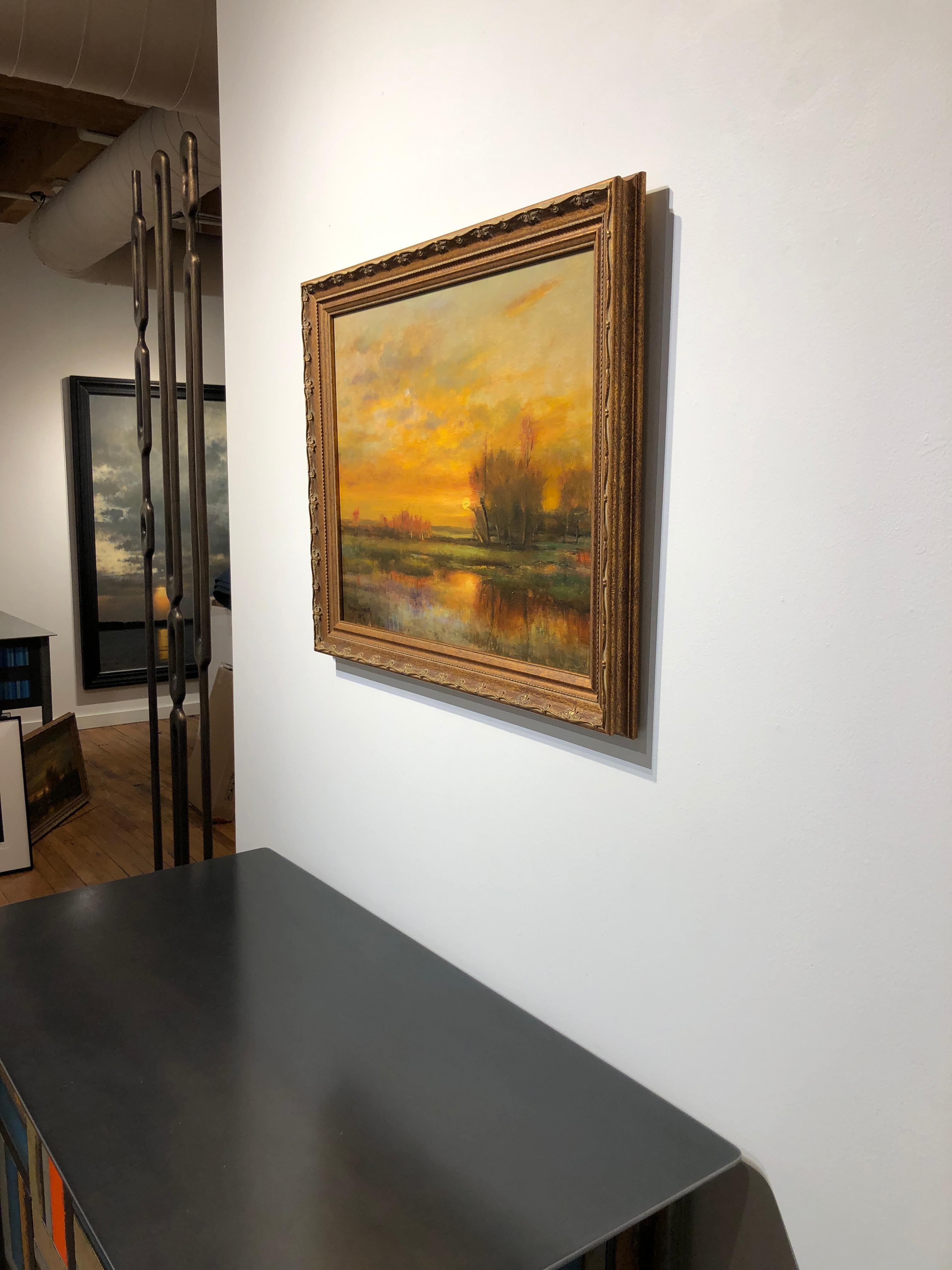 This beautiful landscape painting depicts the sun setting over a marshy field.  The brilliant light of the sun casts its golden rays upon everything it touches, including the tangerine colored sky.  The soft colors of gold, orange and yellow envelop