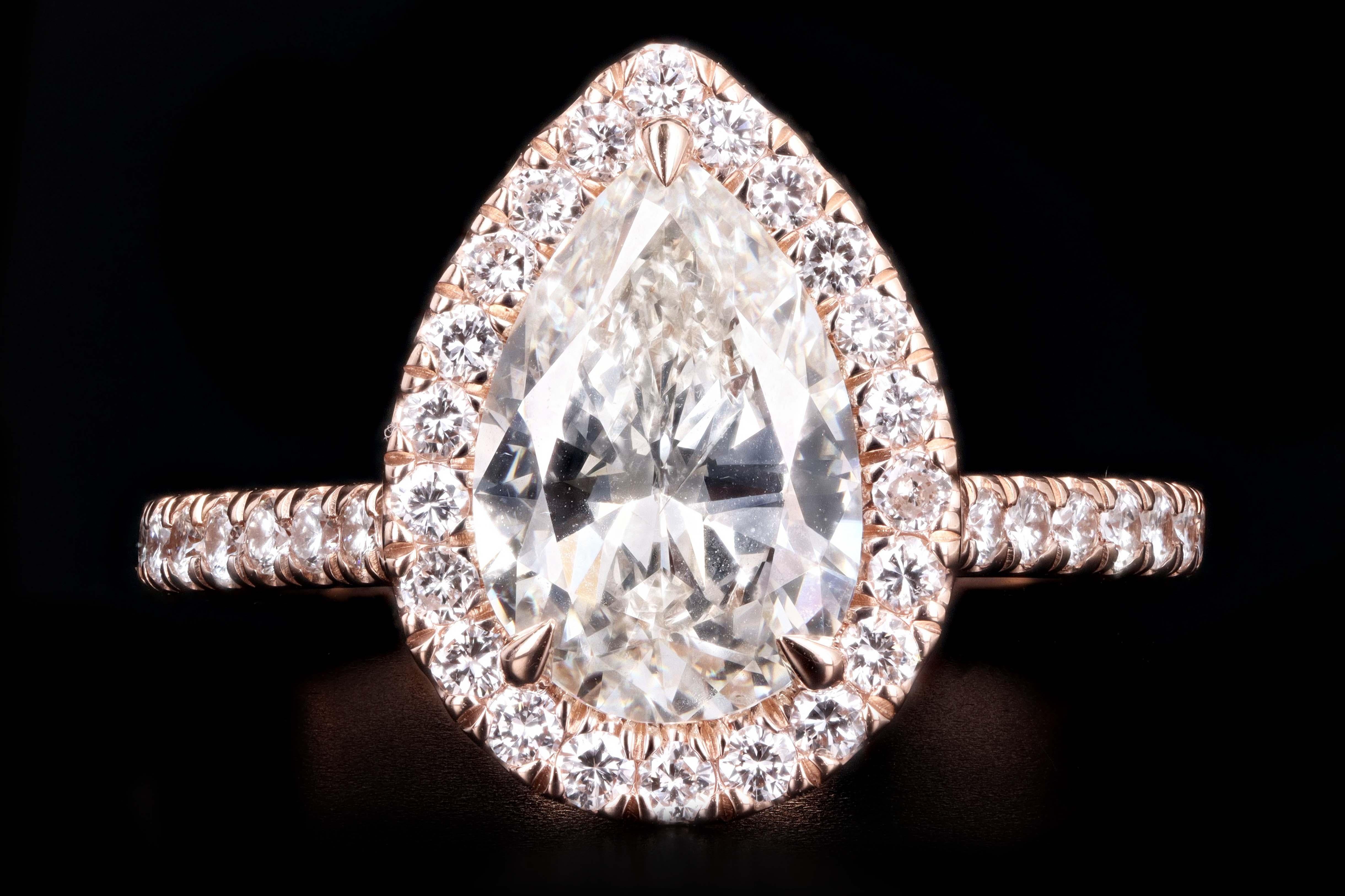 Era: New

Composition: 14K Rose Gold 

Primary Stone: Pear Brilliant Cut Diamond

Stone Carat Weight: 2.10 Carats

Color/ Clarity: I / SI2

Accent Stone: Round Brilliant Cut Diamonds 

Carat Weight: Approximately .50 Carats

Color/ Clarity: