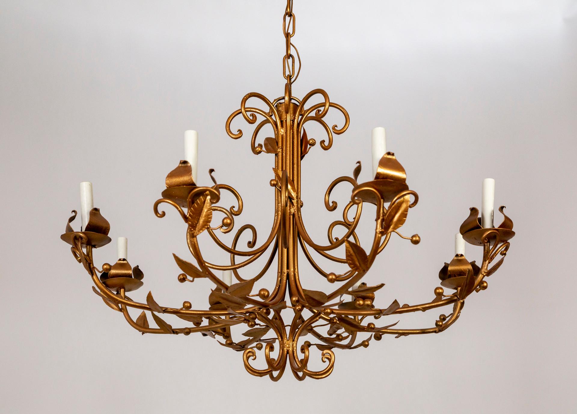 A metal chandelier painted rose gold with curving arms adorned with subtle, simple leaves and berry shapes. Newly rewired. 38.75