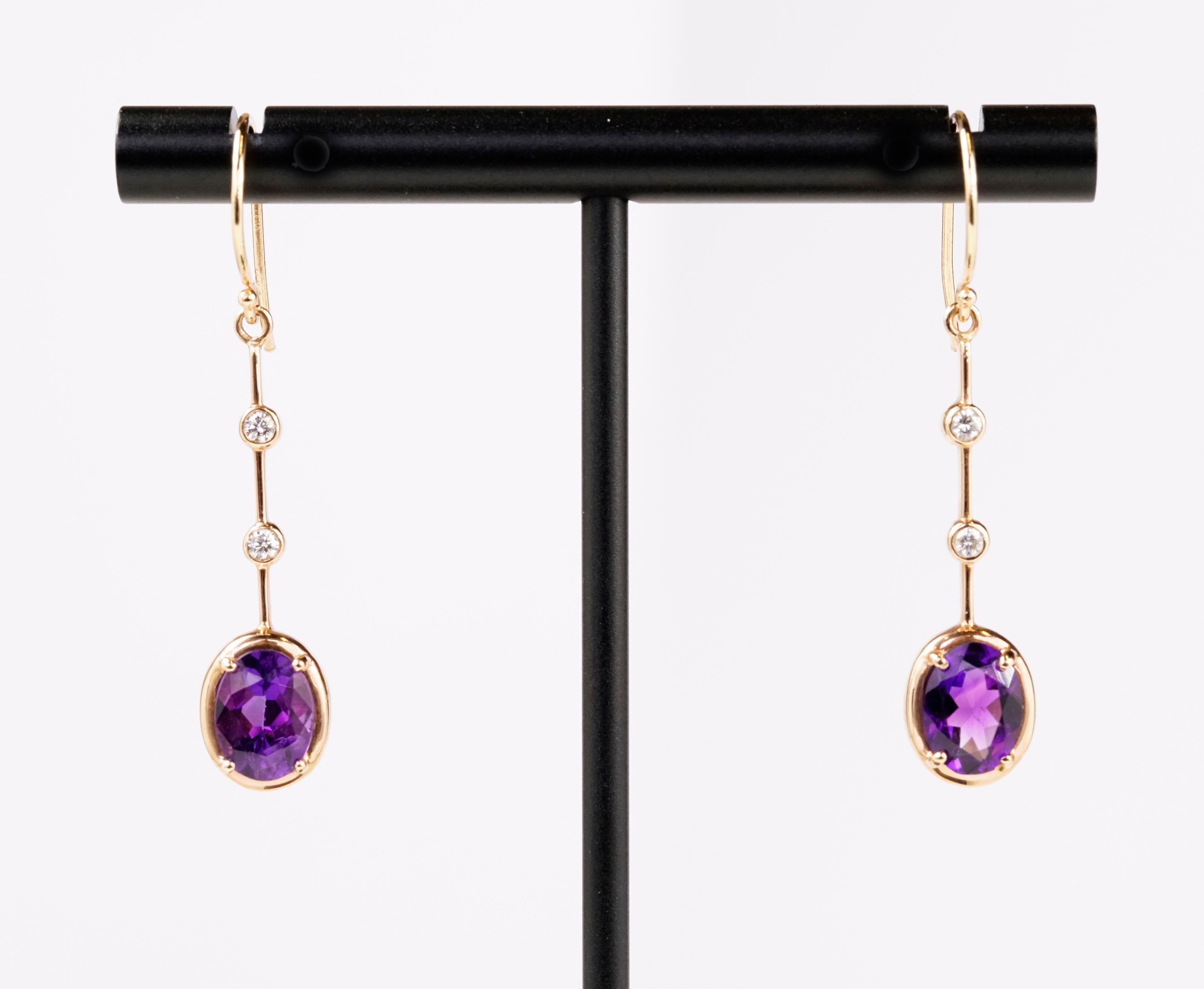 Drop dead gorgeous 14k Rose Gold Earrings set with Natural pair of amethyst ovals 2.10 carats total weight and round brilliant cut diamonds 0.11 carat total weight.
2.21 Carats Total Weight.  