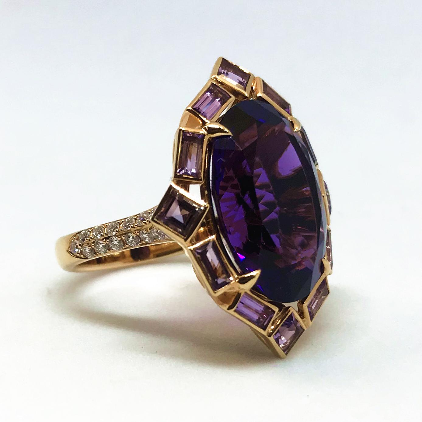 18K rose gold ring centering one oval-cut, faceted purple amethyst held with four prongs and surrounded by individually bezel-set four square-cut and eight baguette-cut light pink amethysts. This centerpiece is mounted on a thin shank partially