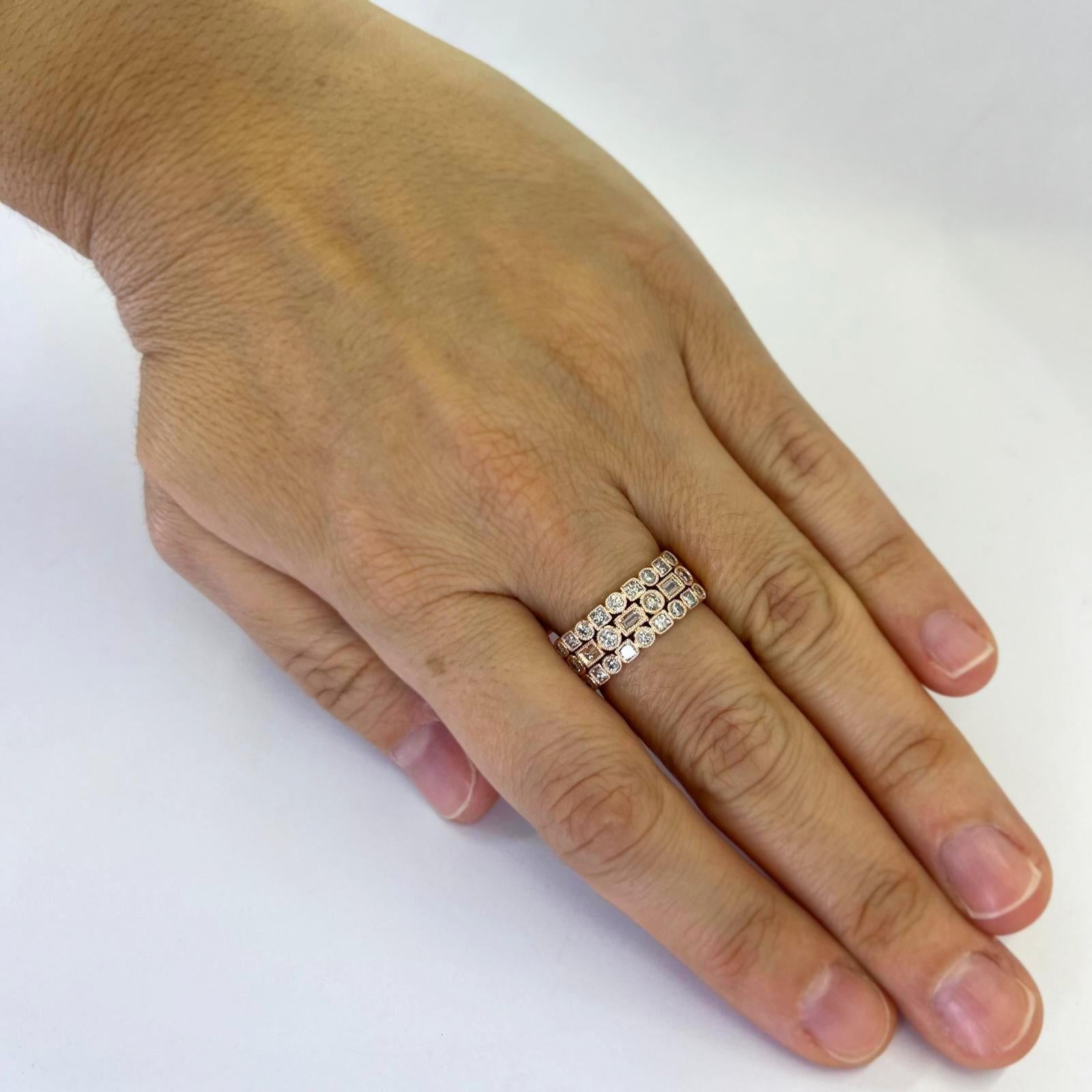 14 karat rose gold 3 row band with millgrain accent featuring 25 round, baguette, and princess cut diamonds of SI clarity and H color totaling approximately 1.00 carat. Tapered design at back. Finger size 7. Includes one sizing service prior to