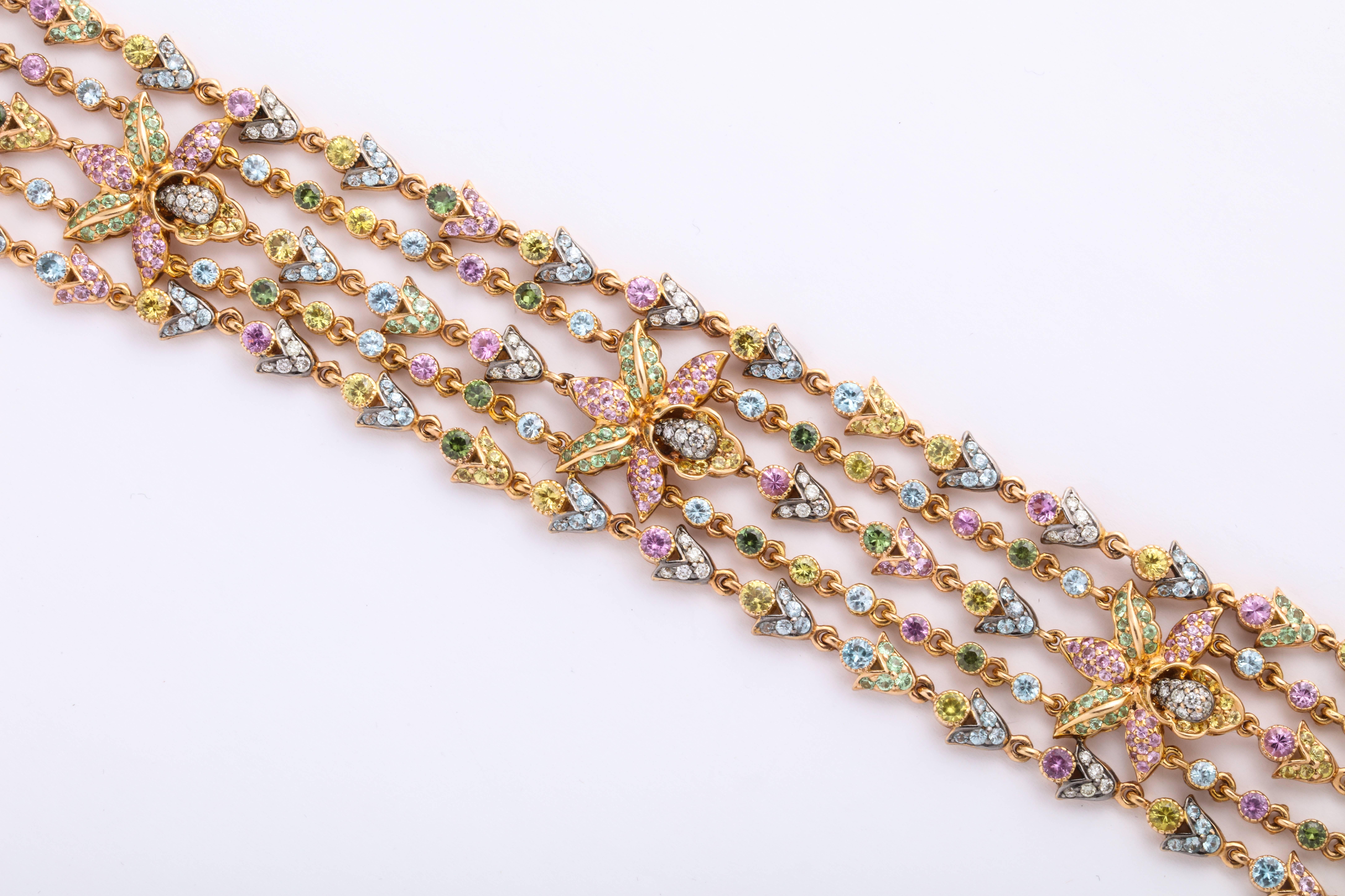 18 Karat Rose Gold articulating 5-strand articulating strap bracelet mounted with 3 FLORAL stations decorated with round brilliant-cut diamonds: 1.57 carats, yellow sapphires: 2.98 carats, green garnets (tsavorite): 2.06 carats, yellow sapphires: