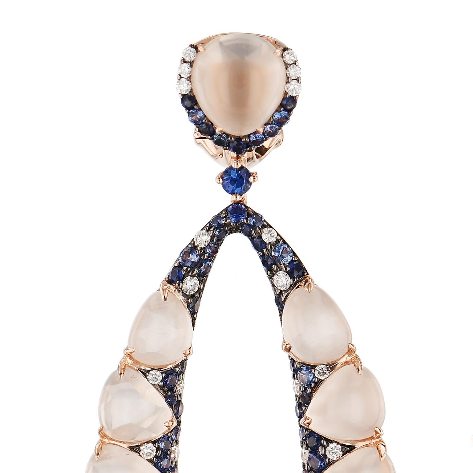 Adorned with sapphires(2.57 carats in total weight) and diamonds (0.73 carats in total weight), these 18 karat rose gold earrings share the brilliance of moonlight captured in cabochon cut moonstones with a total weight of 33.86 carats. 