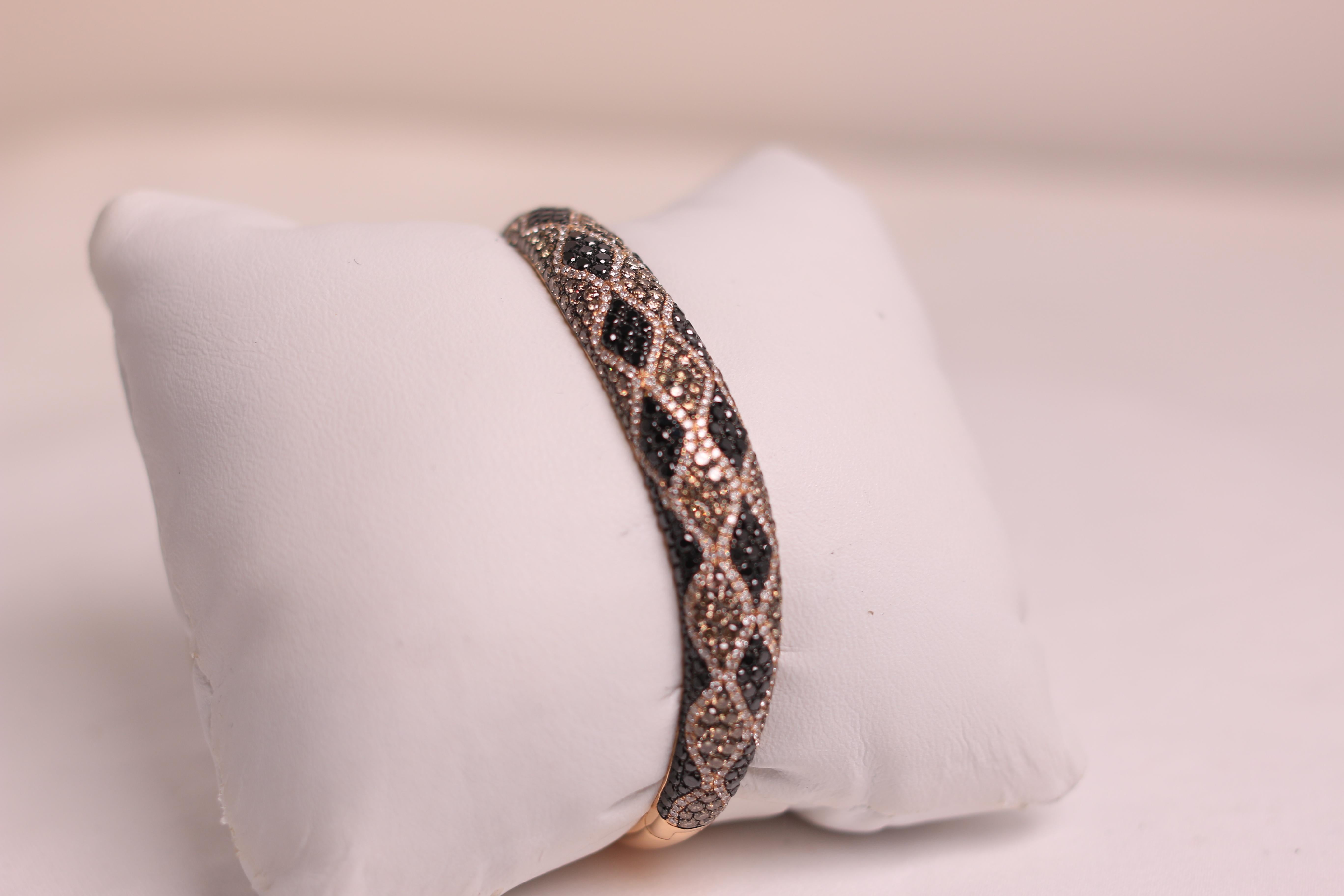 Fashion bangle with multi-color diamonds set in 18k rose gold. Bangle carries 2.11ct in round black diamonds, 2.25 in round champagne diamonds, and 0.98ct in round white diamonds. Giving this bangle a grand total of 5.34ct of diamonds. Stamped 18k J