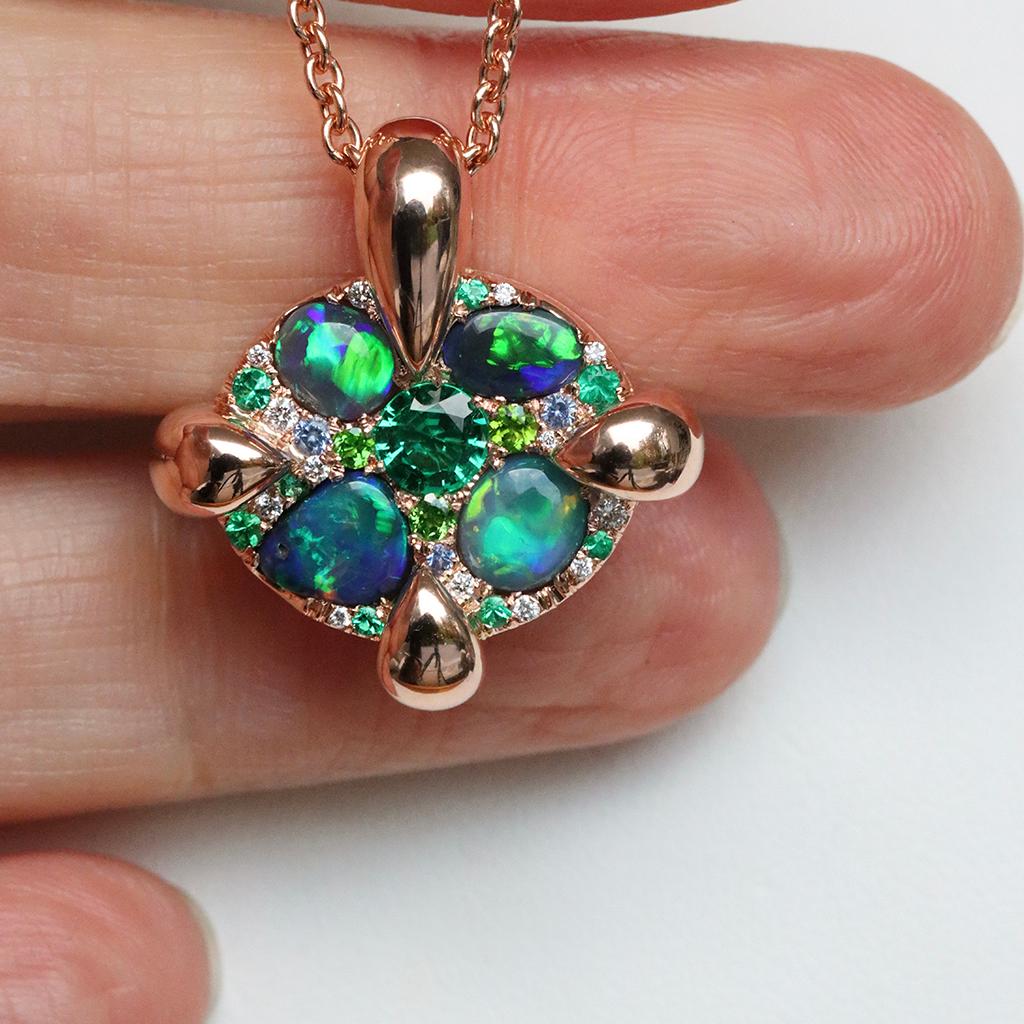 Unveil the beauty of Belgian craftsmanship with this handmade rose gold multi-stone pendant, featuring Black Lightning Ridge Opal Cabochons, Colombian Emeralds, No heat Blue Sapphires, Demantoid Garnet and white Brilliant-cut diamonds. 

Each gem is