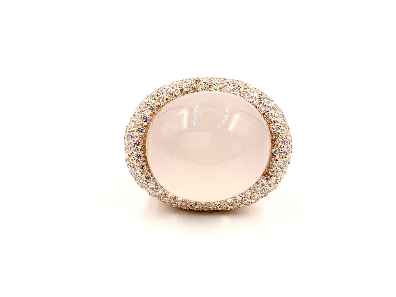 A unique modern statement piece. This high-polished 14 karat rose gold large cocktail ring features a pastel, baby pink cabochon domed rose quartz surrounded by 1.80 carats of high quality diamonds for a generous amount of sparkle that contrasts