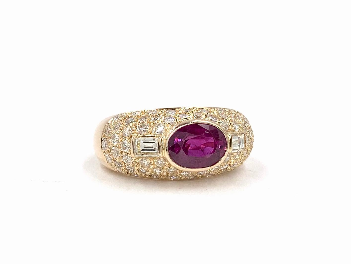 A wearable and beautiful 14 karat rose gold low dome ring featuring a 1.57 carat oval ruby and 1.20 carats of white diamonds. Oval ruby and two baguette diamonds are bezel set for a low profile surrounded by perfectly pave set diamonds. Ruby is of