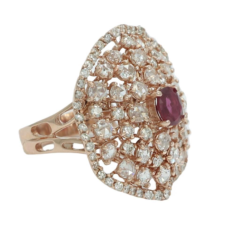 14K Rose Gold Diamond and Ruby Ring. It Has 1 Burmese Ruby Weighing 0.63 Carats Total Weight, 28 Rose Cut Diamonds F/VS Weighing 1.42 Carats Total Weight, and 72 Round Brilliant Cut Diamonds H/VS Weighing 1.11 Carats Total Weight. The Ring Sits At a