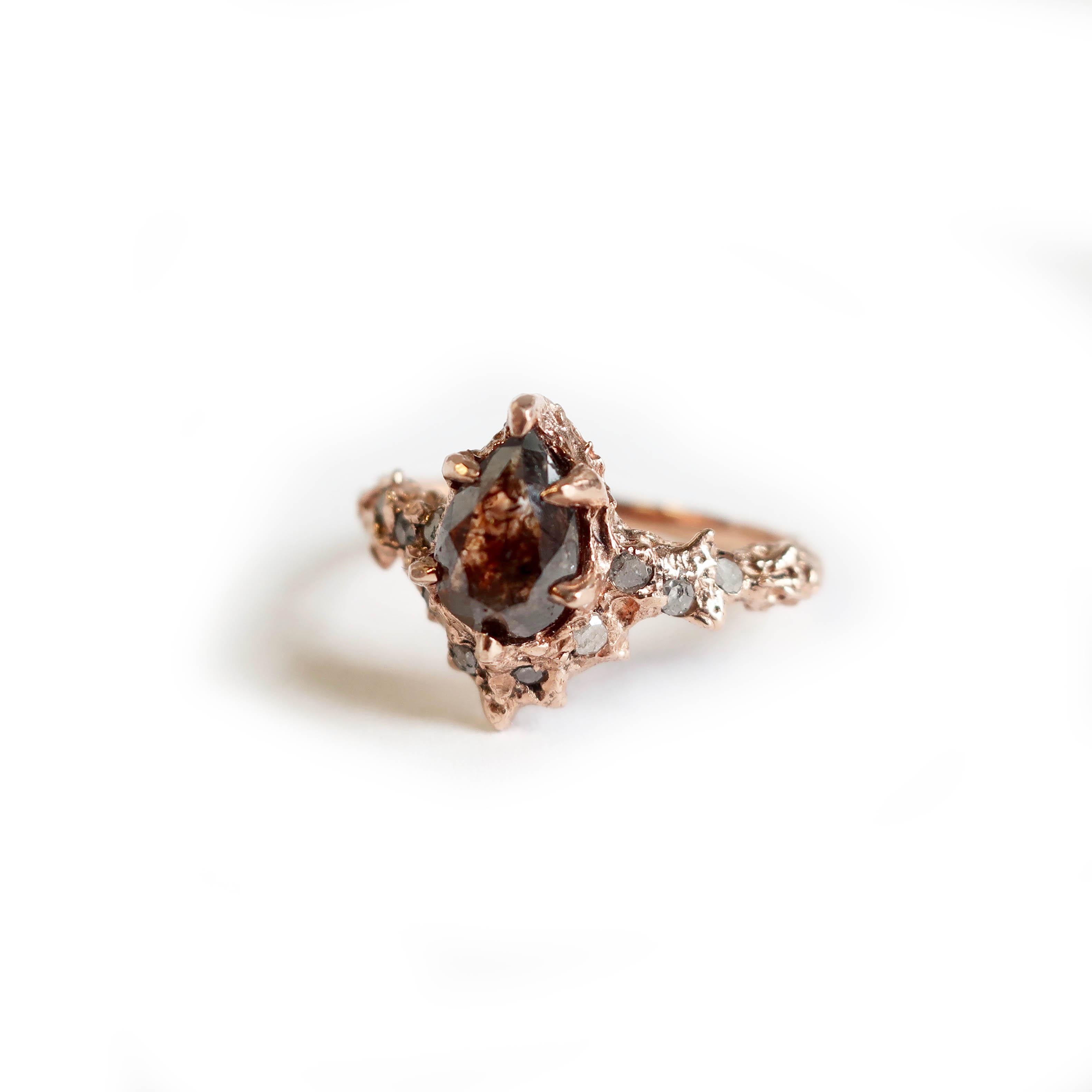 A brown rose cut diamond encased in 14k rose gold with 11 icy 1.5 mm side diamonds. 1.55 carat diamond with salt and pepper pave diamonds scattered throughout . This item can be customized with various stone and metal options.

Size 7.5

Natural