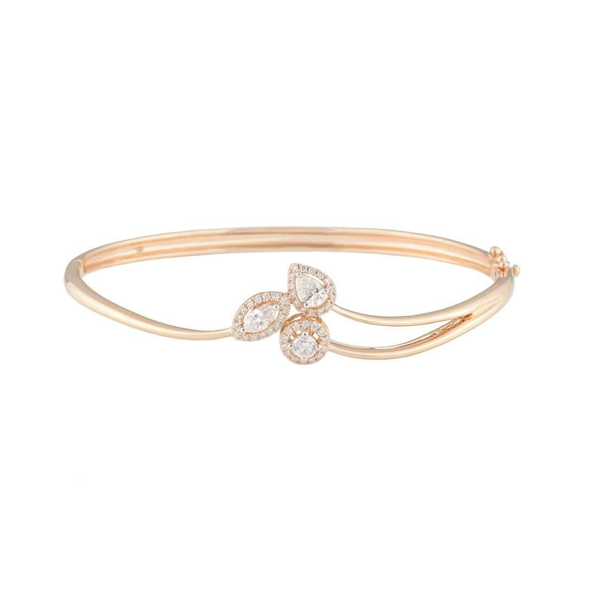 A lovely 18k rose gold diamond bangle. The bangle comprises of round brilliant cut, pear cut and marquise cut diamonds with a halo of diamonds around each. The diamonds have a total weight of 2.07ct, G-H colour and VS-VVS clarity. The bangle