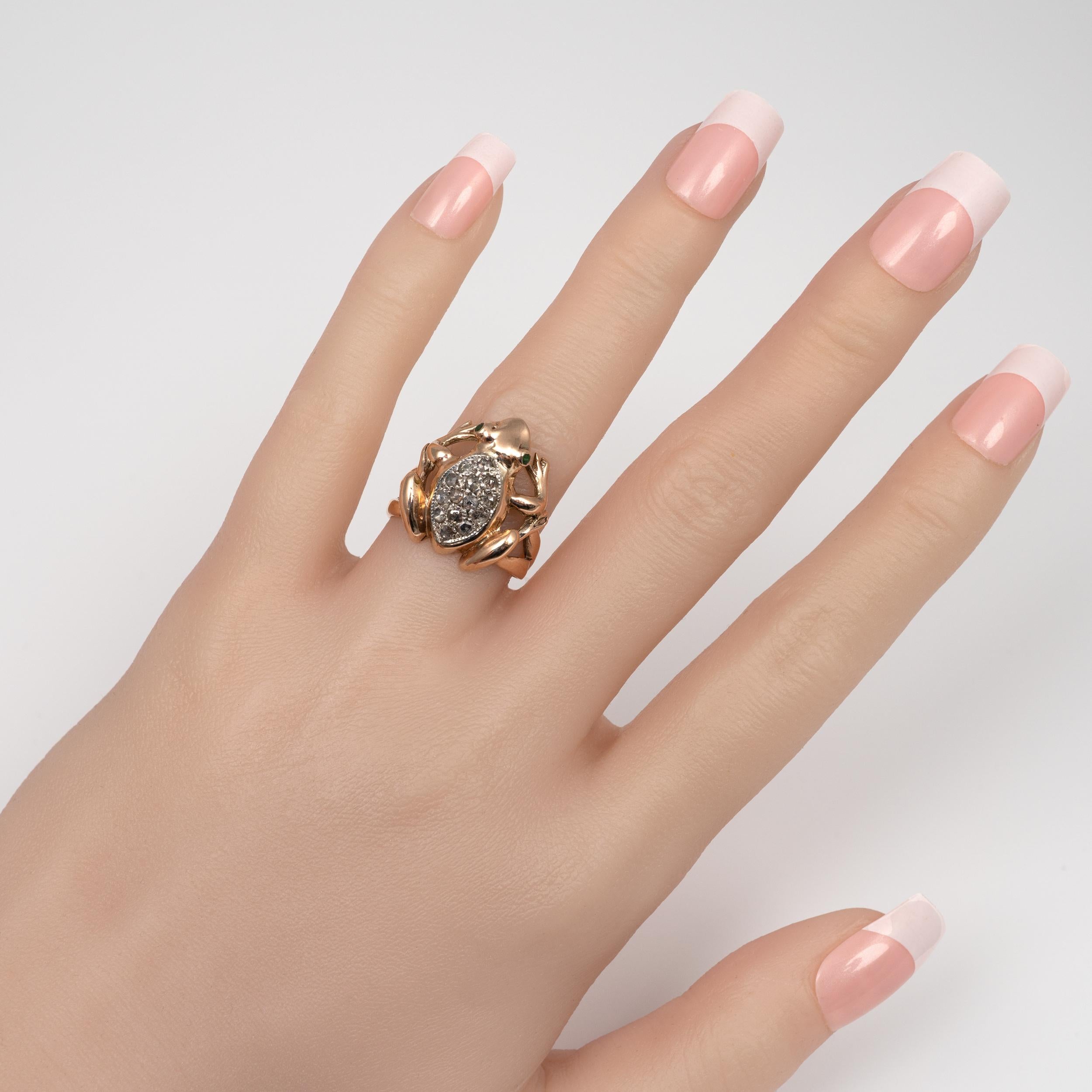 A very cute rose gold Frog ring set with old cut diamonds and emeralds. Circa 1970s
The chunky frog is nicely modeled in a realistic fashion. It features a white gold marquis shape setting that is bejeweled with 14 paved set rose cut diamonds and