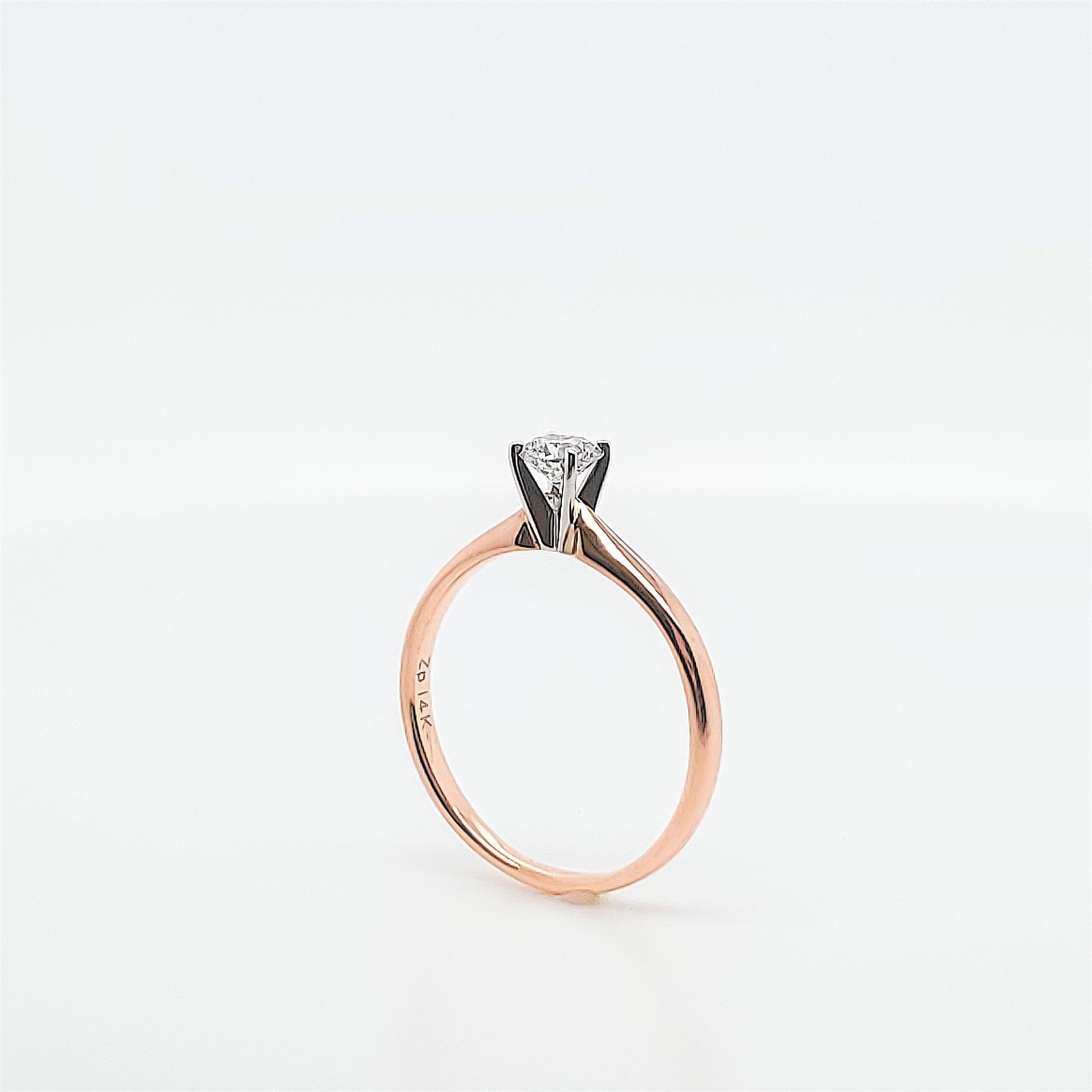 Diamond Solitaire engagement ring crafted in 14 karat rose gold.  Featuring a single round brilliant ct diamond weighing approximately .26ct, G color, SI2 clarity.  Signed Zp, 14K.  Size 6 1/2, can be sized.  Circa 2010s