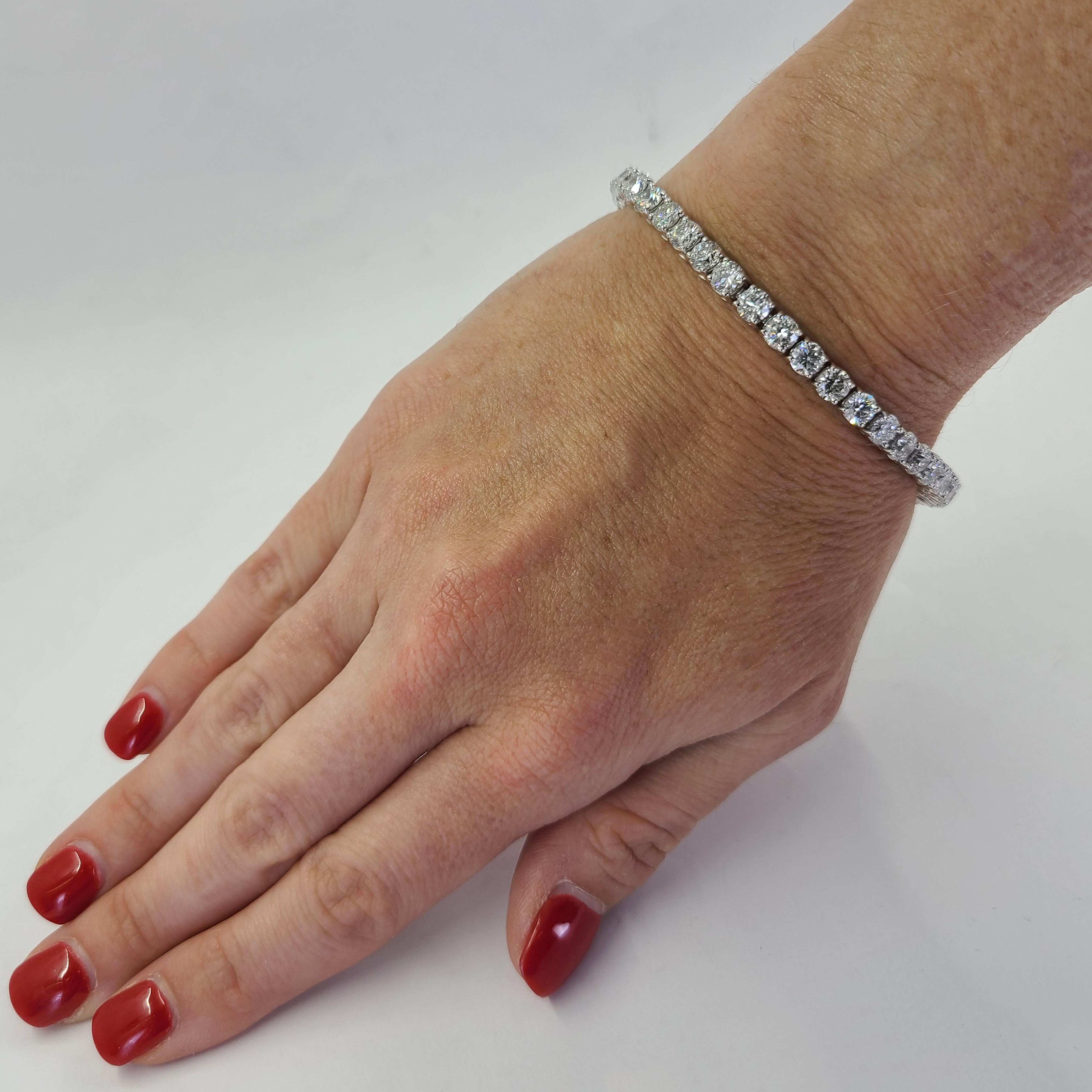 14 Karat White Gold Tennis Bracelet Featuring 39 Round Brilliant Cut Diamonds of SI2/I1 Clarity & G/H Color Totaling 12.66 Carats. 7 Inch Length with Hidden Box Clasp & Safety Latch. Finished Weight Is 22.6 Grams. Can Be Shortened Upon Request To