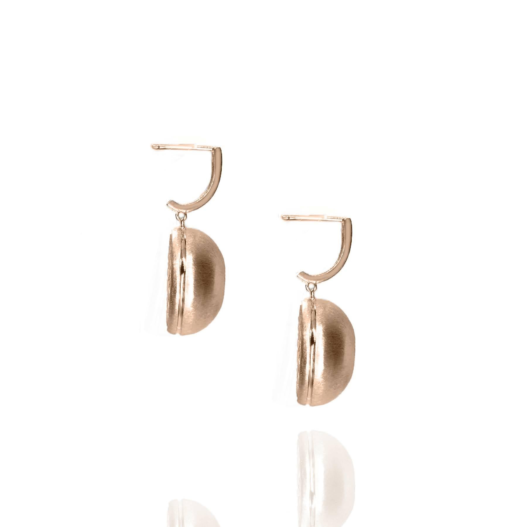 These White Sapphire in Rose Gold Dome Drop Earrings, part of our Power Series, are a symbolic design inspired by the idea of looking inward, the notion of what a person needs is already inside of them. The clean and classic lines are imaginative,