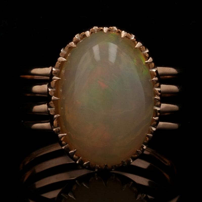 Size: 6 1/4

Metal Content: 18k Rose Gold

Stone Information
Genuine Ethiopian Opal
Carat: 6.20ct
Cut: Oval Cabochon

Style: Cocktail Solitaire

Measurements
Face Height (north to south): 5/8