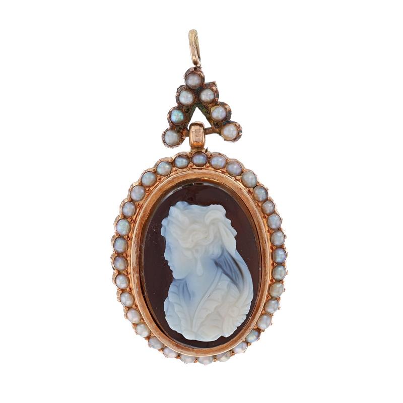 Era: Victorian
Date: 1870s - 1880s

Metal Content: 14k Rose Gold

Stone Information
Natural Hardstone Banded Agate
Cut: Carved Cameo
Size: 19mm x 13.4mm

Cultured Seed Pearls

Theme: Woman's Silhouette

Measurements
Tall (from extended bail): 1 1/2