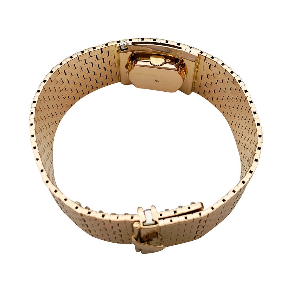 A 18K rose gold International watch Compagnie large bracelet mysterious watch, made with nine gold links rows. 
Mysterious watch hiding under a hood imitating the pattern of the bracelet.
Hidden dial, silver colour, applied hours markers. 
Manual