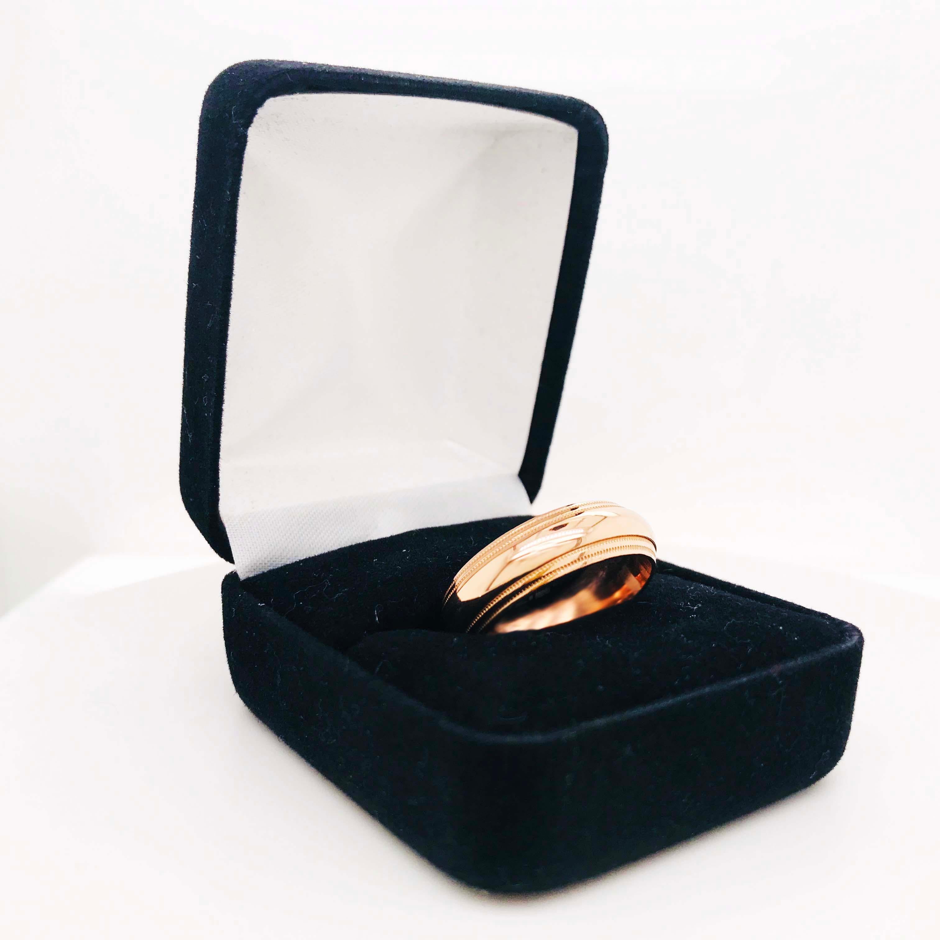 This custom rose gold band ring is a unique design with a classic structure. The band is a curved style (half round band) with a double beaded pattern near the edges of the ring. The band is 6 1/2 mm wide and made with a rich 14 karat rose gold! The