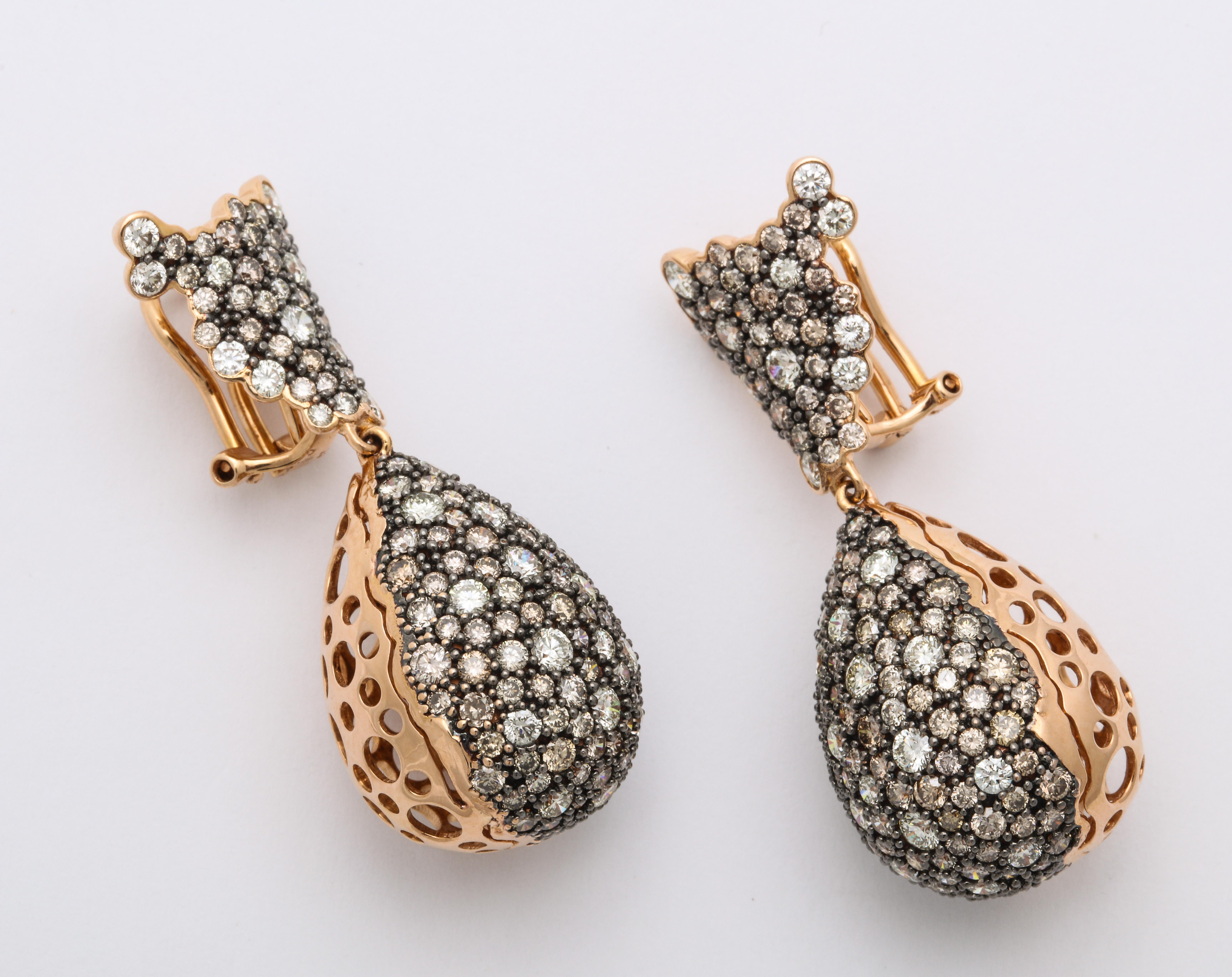 Bohemian chic 18K rose gold stylized ear pendants configured with a scalloped cone-shaped ear component suspending a voluminous pear-shape drop (with a filigree finish on the flip side), decorated entirely with pave'-set, round brillinat-cut natural