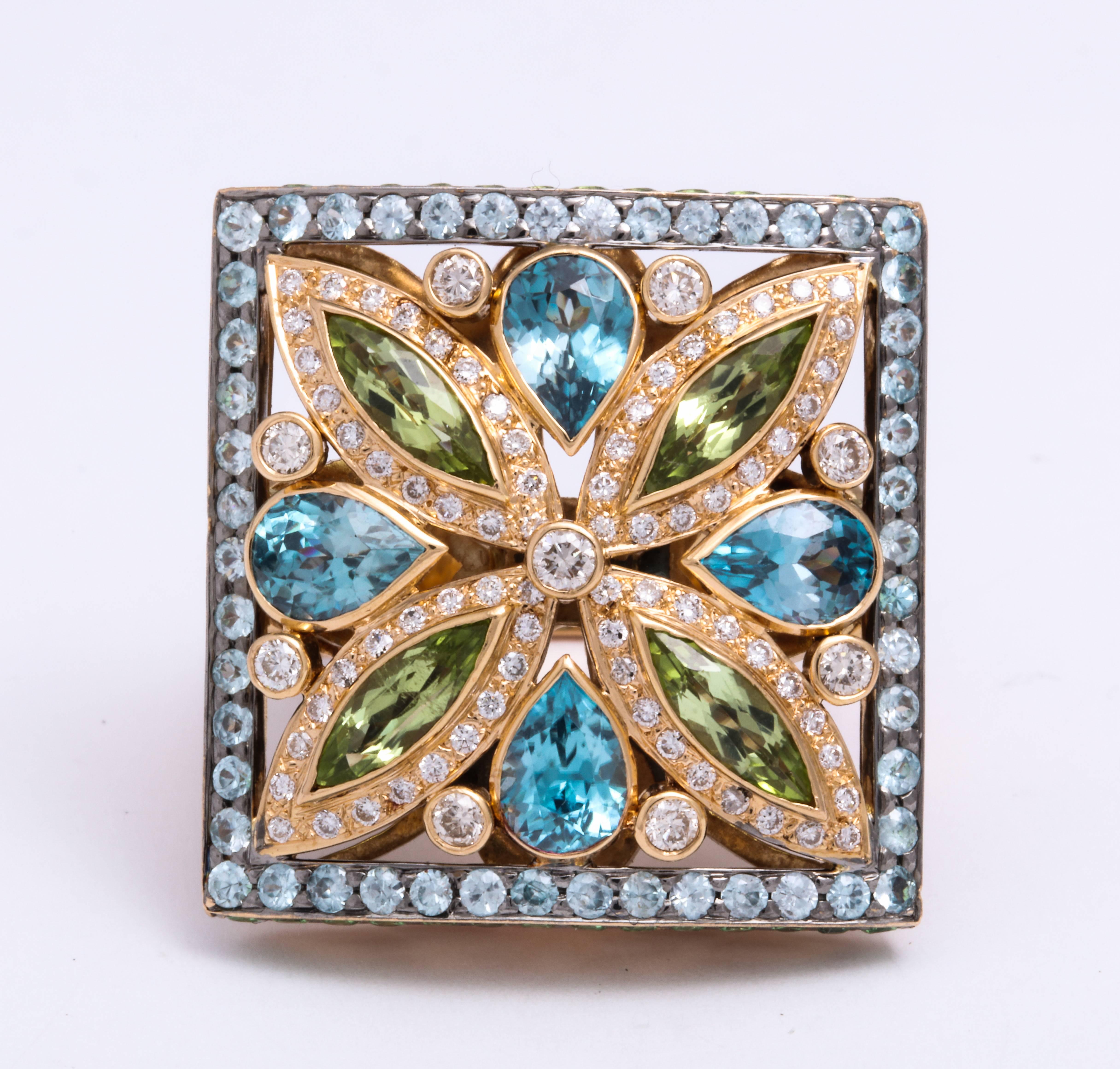 Stylish 18 Karat rose gold bohemian chic geometric cocktail ring symmetrically mounted with marquise peridot: 1.24 carats and pear-shaped blue zircon: 6.10 carats, decorated with pave'-set brilliant-cut diamond frame: 0.81 carats, and round green