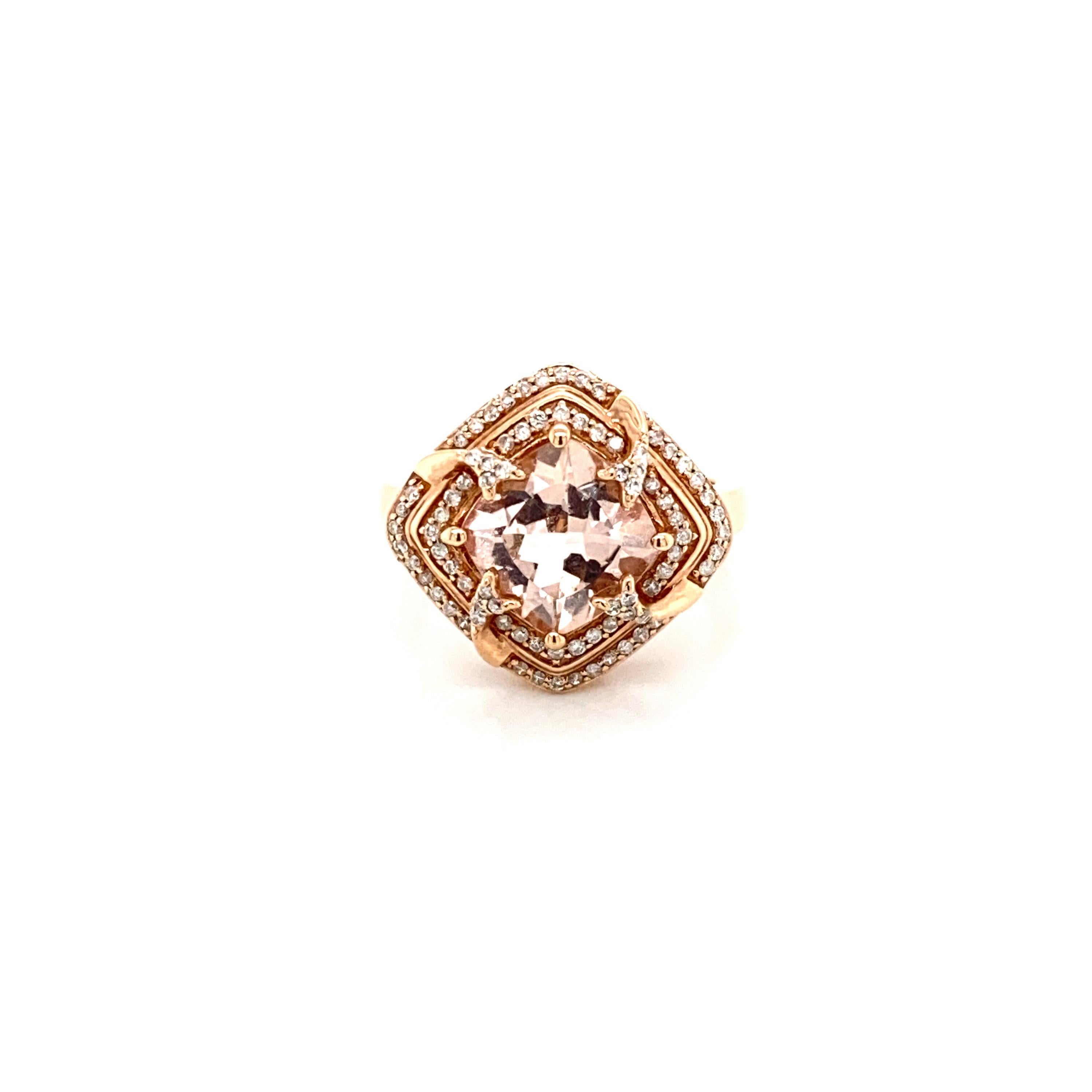 This stunning natural morganite and diamond double halo ring is set in solid 14K rose gold. The natural 2.89 Ct Cushion cut morganite has an excellent peachy pink color (AAA quality gem) and is surrounded by a double halo of round cut white